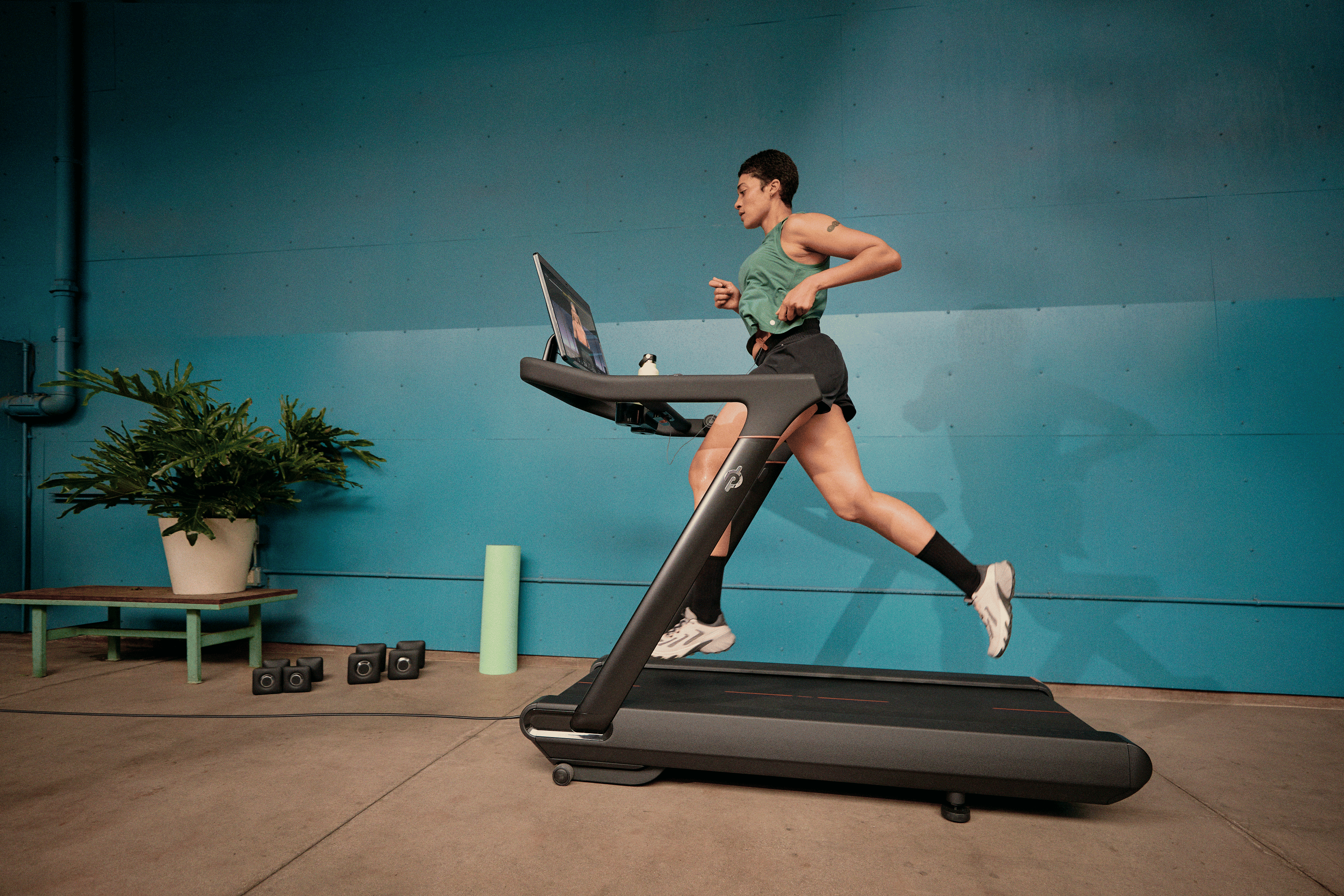 Person doing speed work running on a Peloton treadmill 