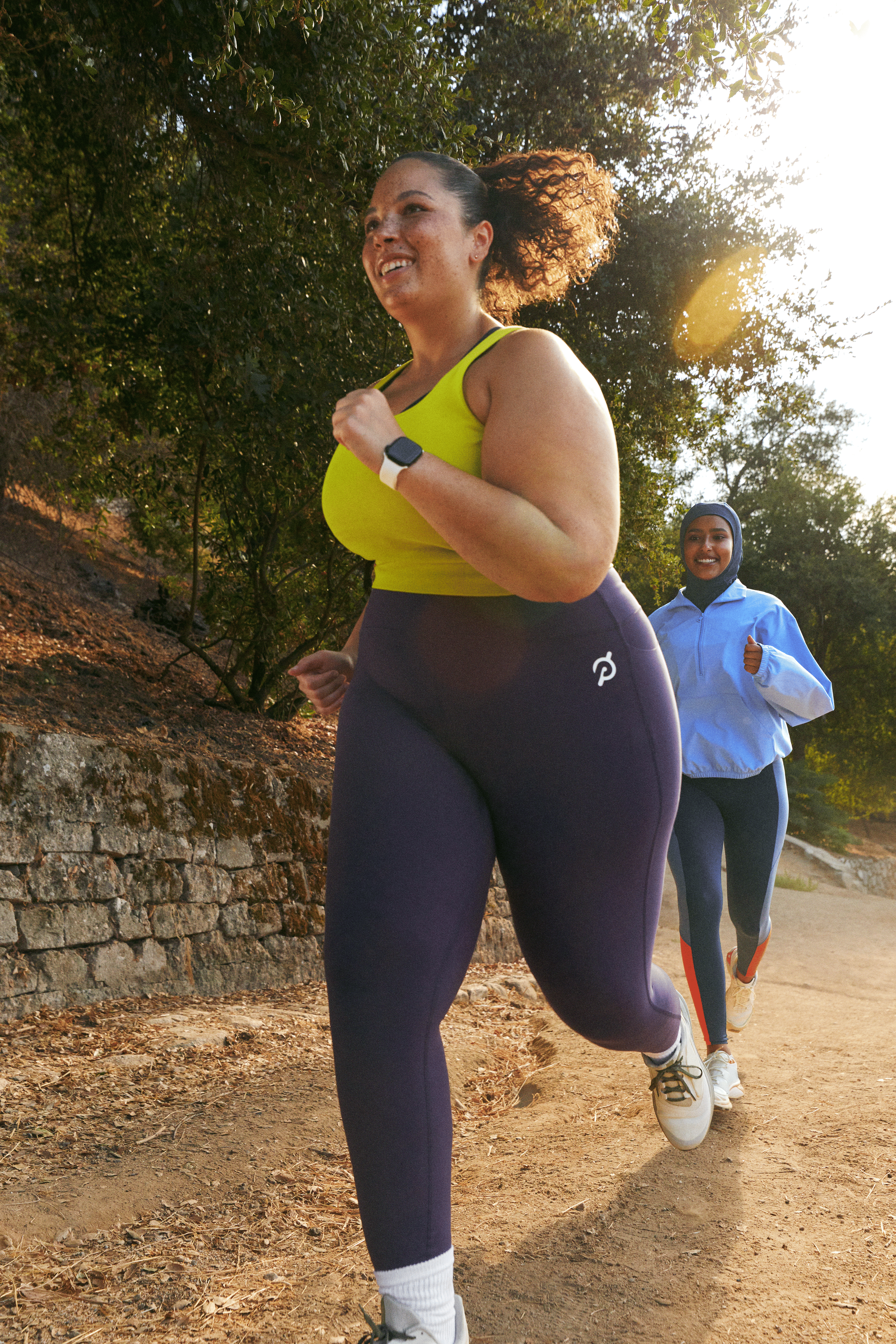 Woman running outside with a run group while training for a 5K.