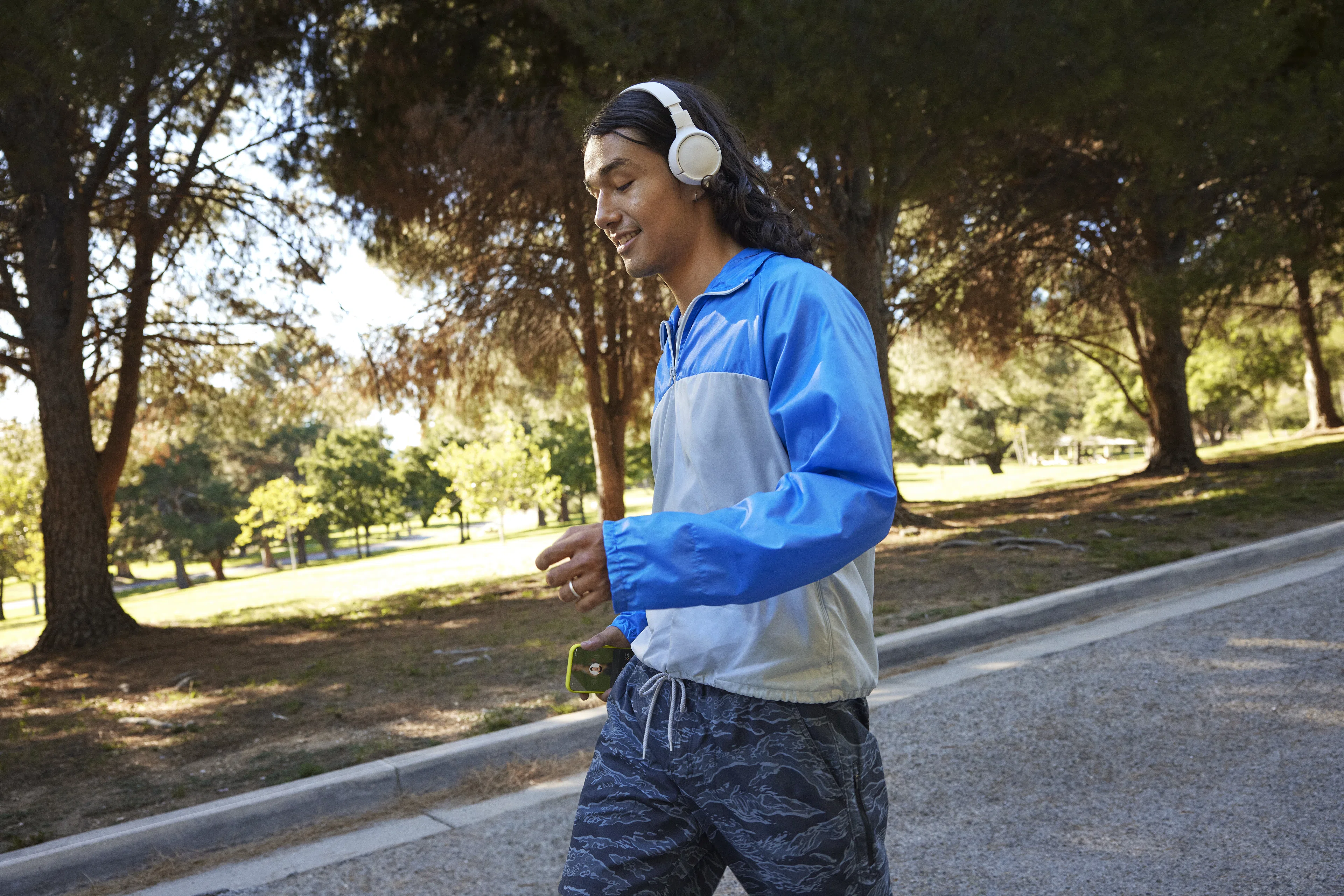 Man walks outside wearing headphones