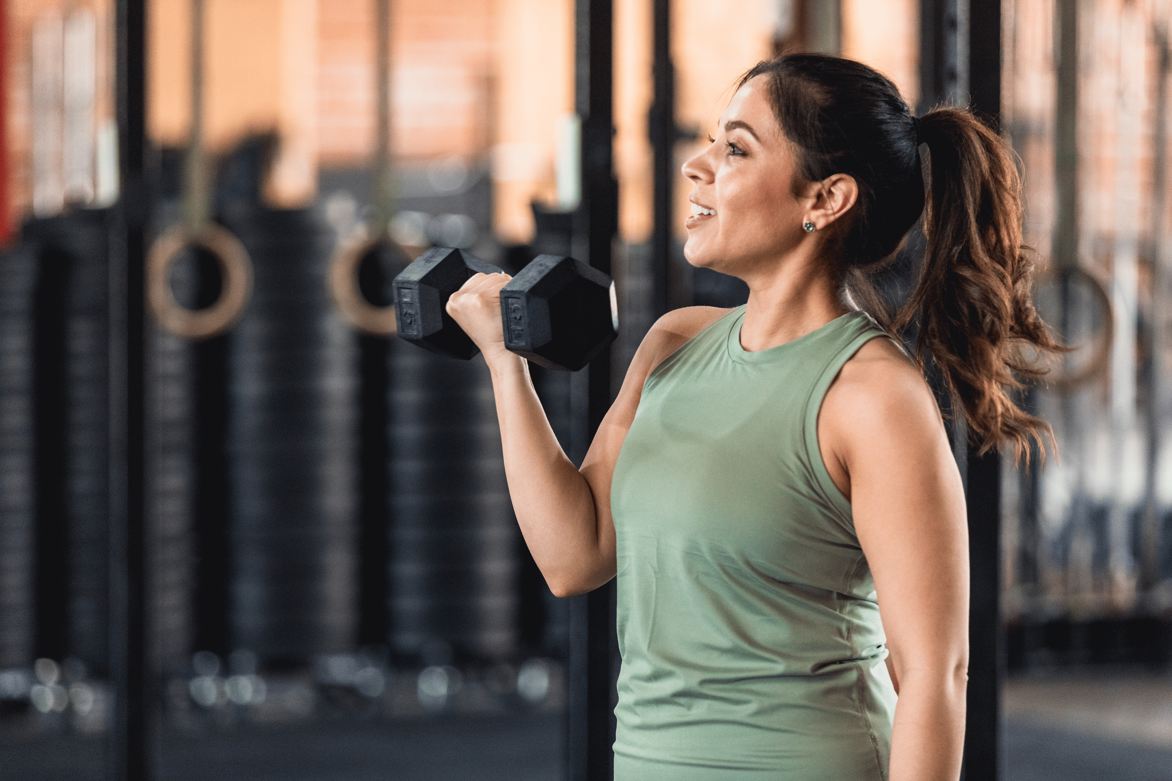 Woman lifts weight at gym
