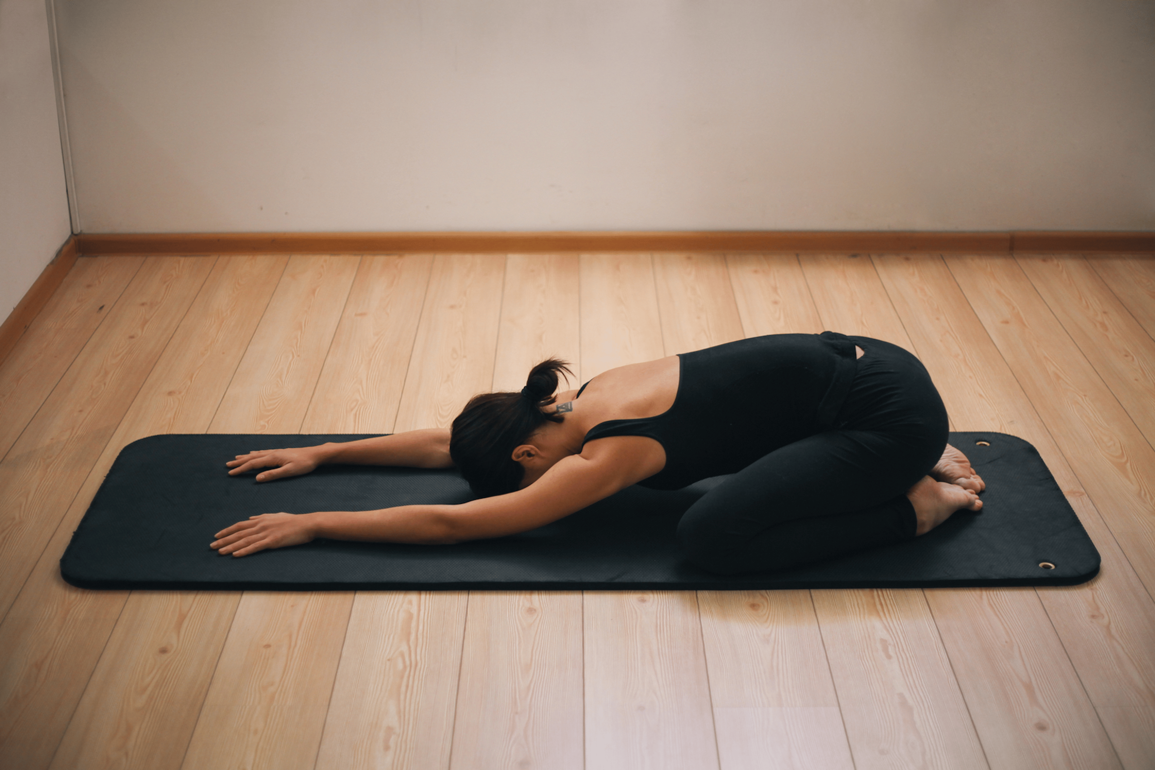 Woman in Child's Pose, a gentle yoga pose