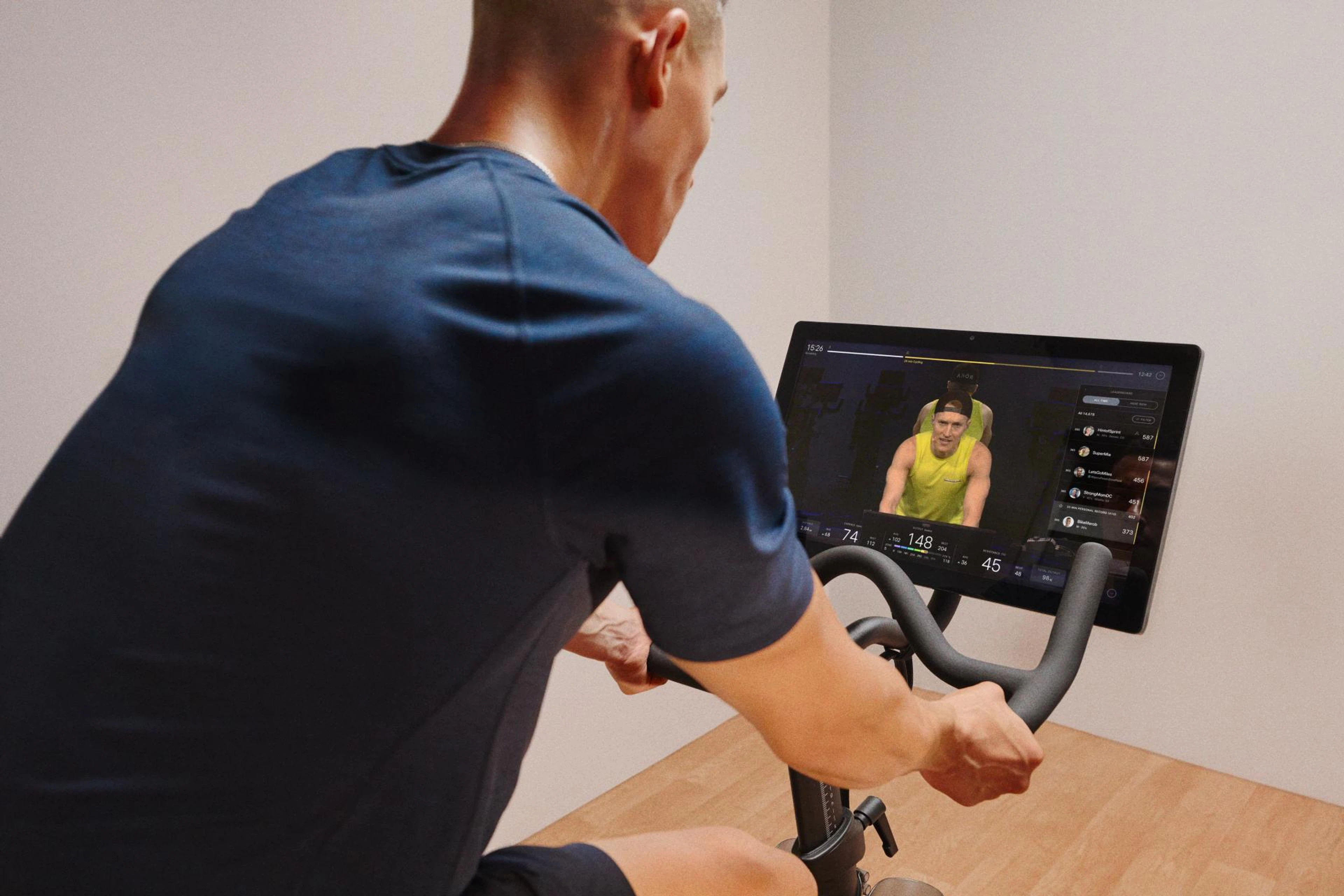 man taking one of peloton's best cycling class on bike