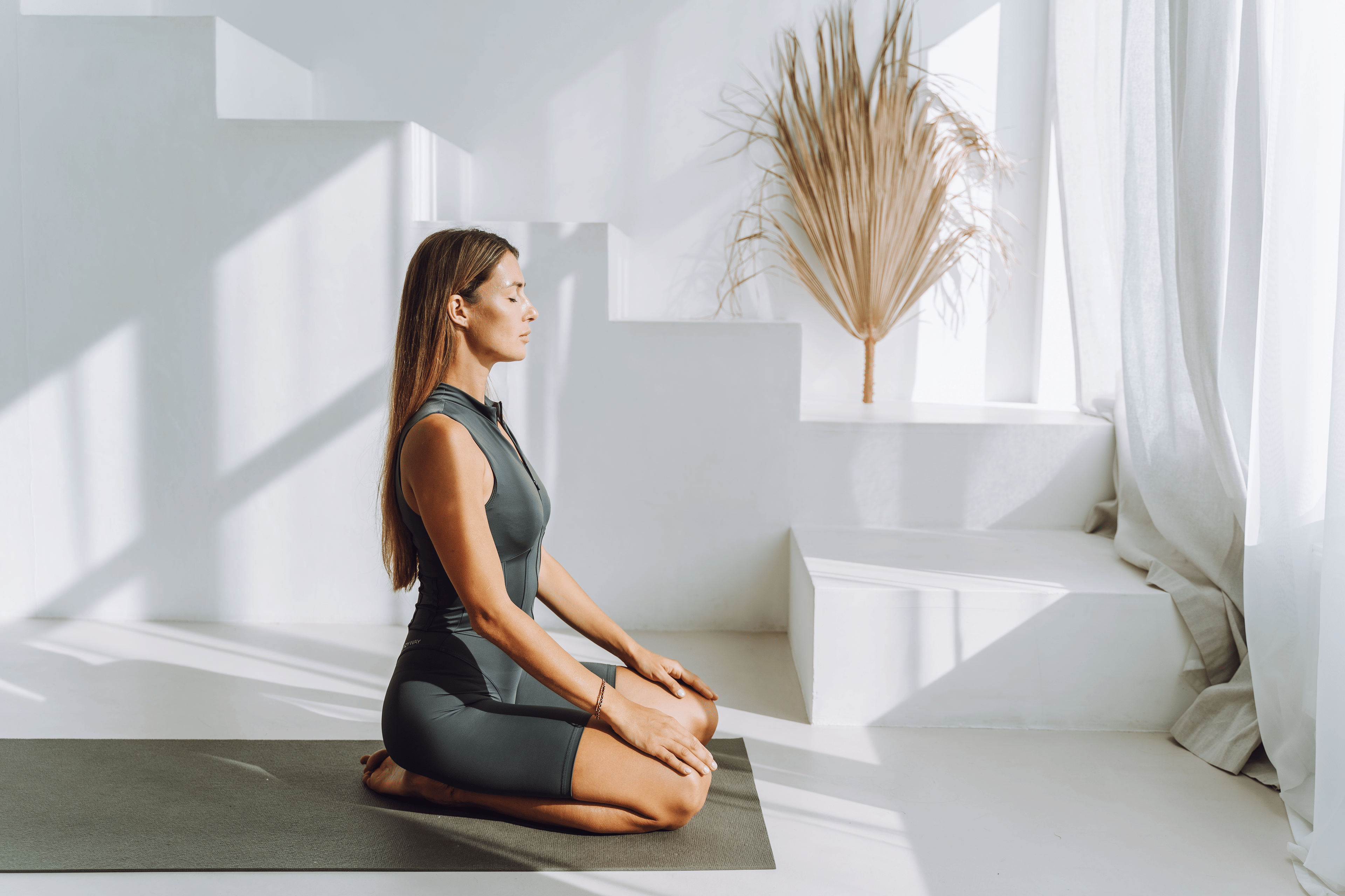 Woman practices Hero Pose in yoga