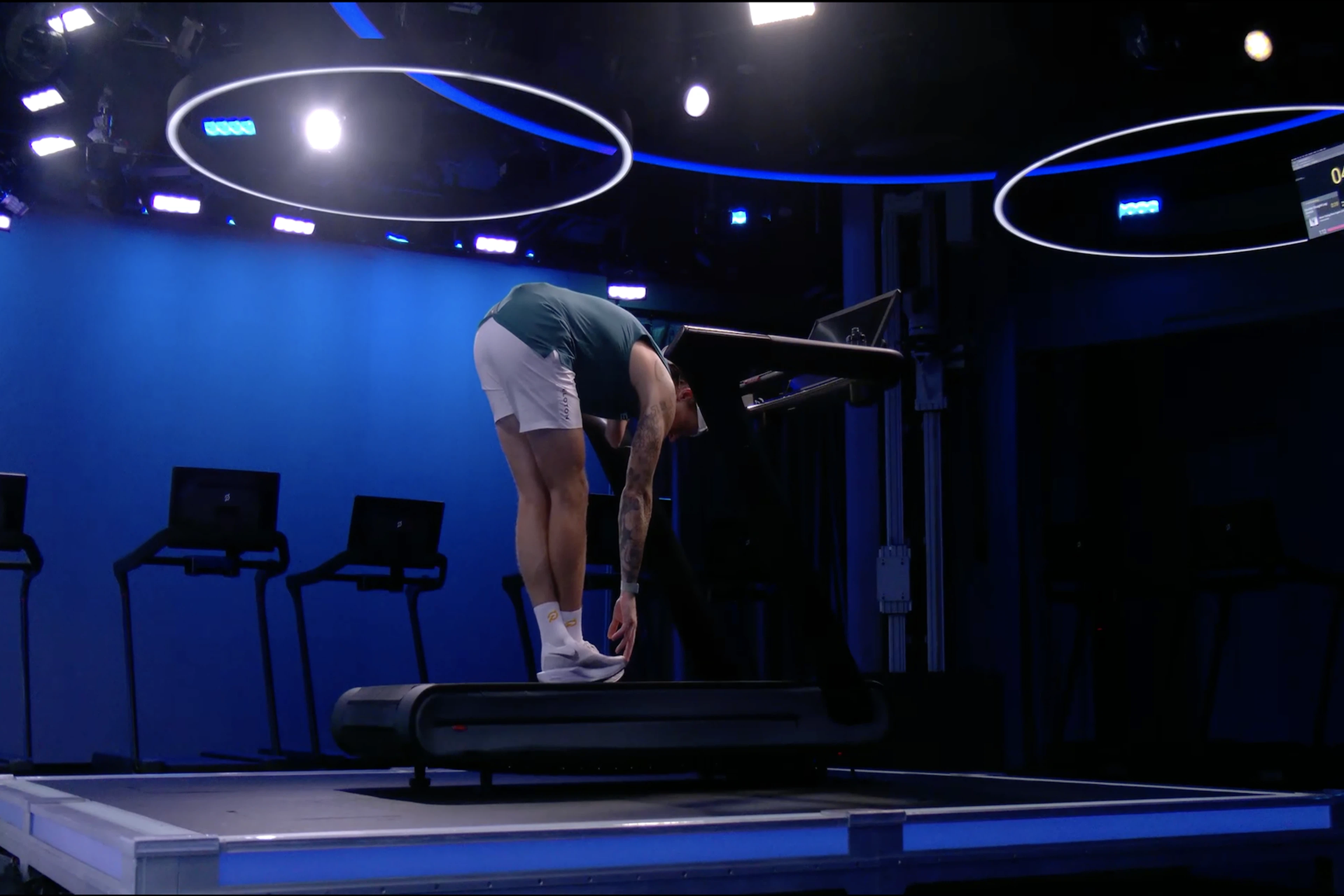 Man demonstrates a standing forward fold, an IT band stretch