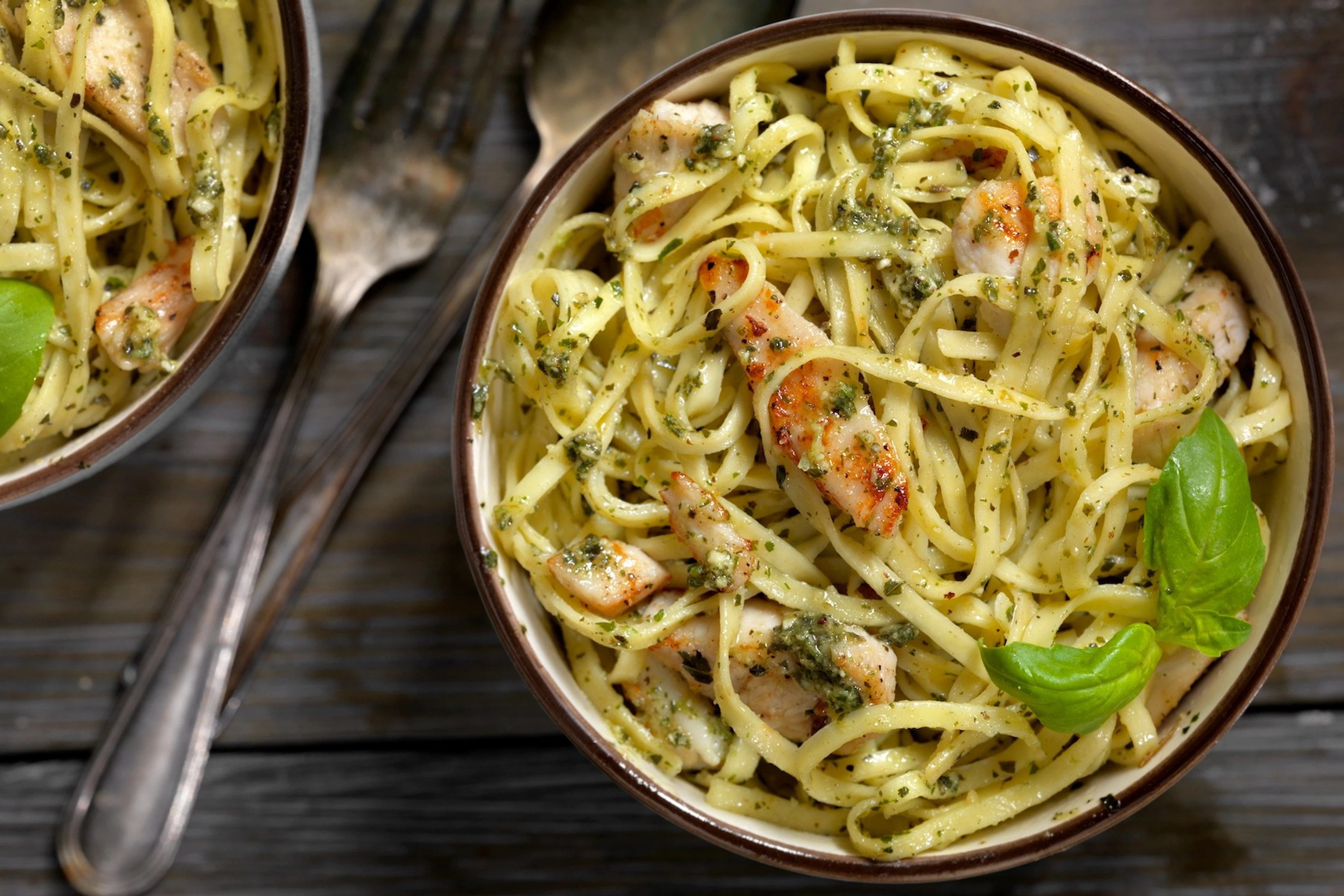 Overhead photo of a plate of basil fettuccine with grilled chicken, which is generally a good thing to eat the night before a race.