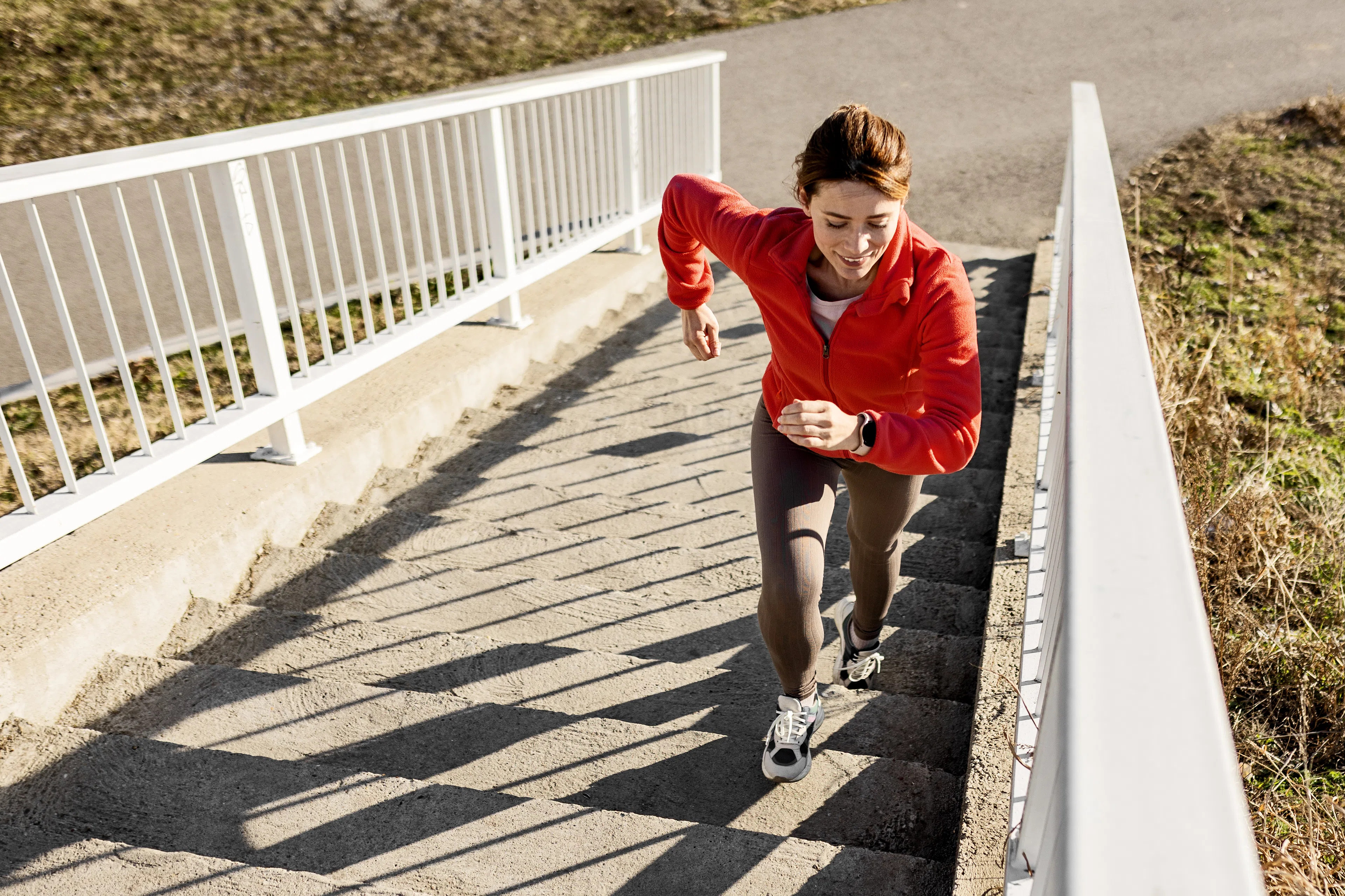 Woman runs on stairs outdoors 
