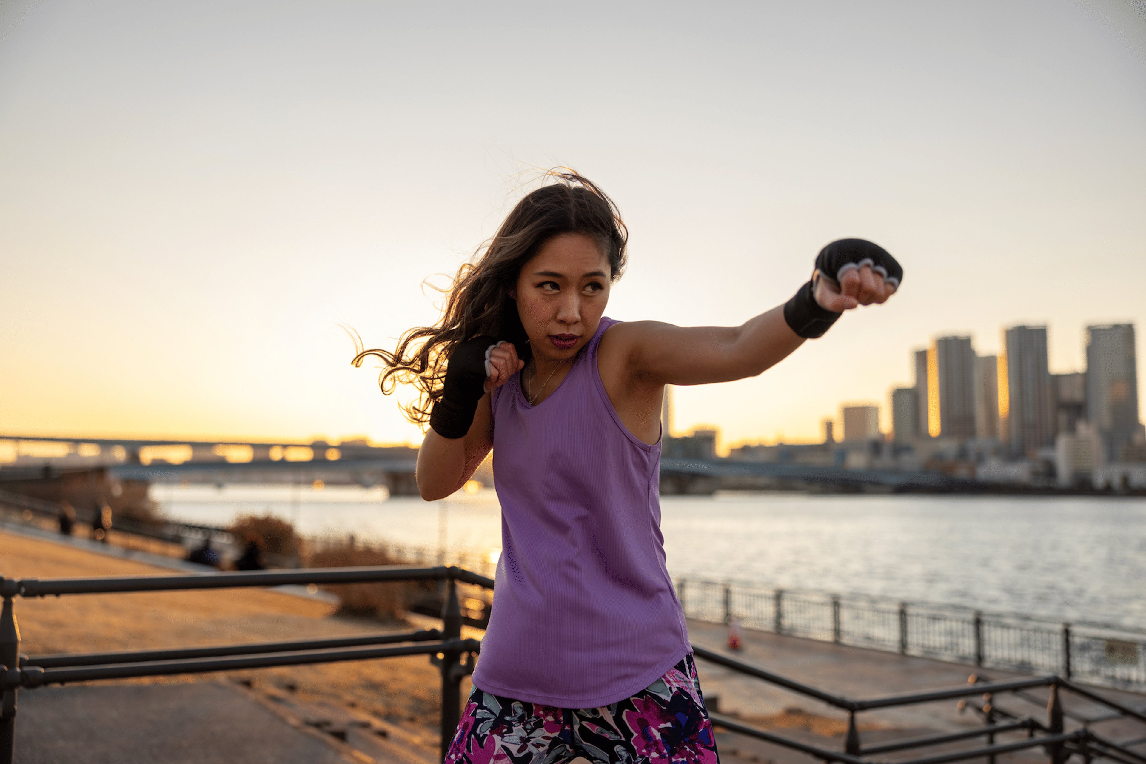 Woman throws a jab in boxing outside
