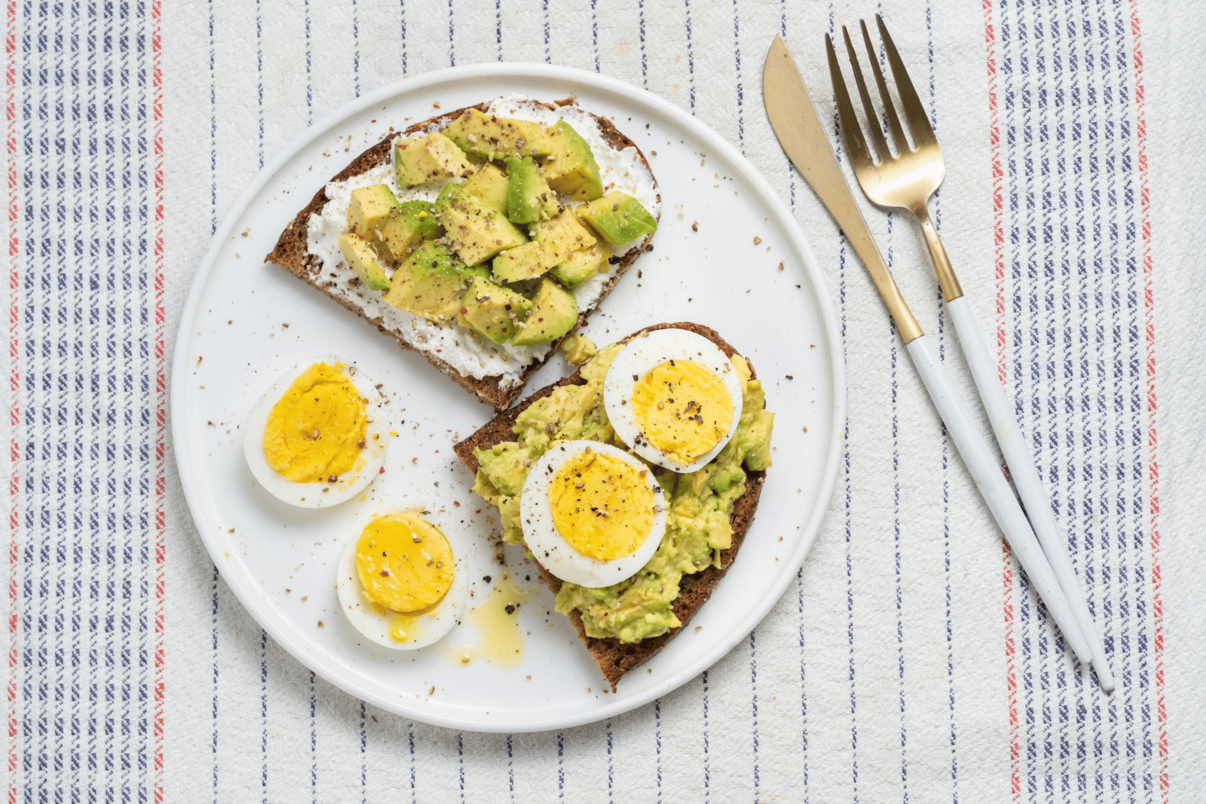 Boiled eggs served on avocado toast.