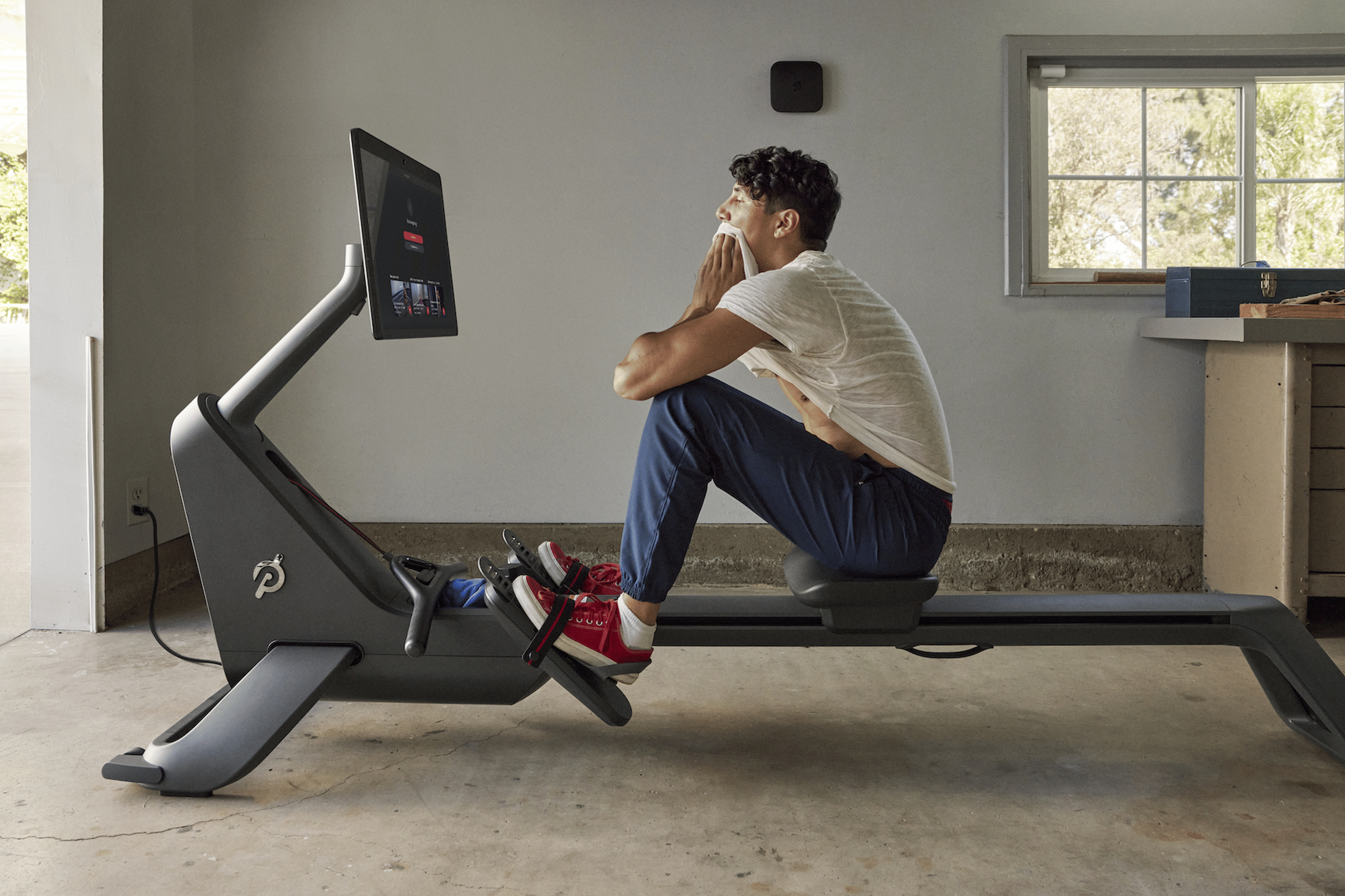 Man looks at his split time after finishing a rowing workout