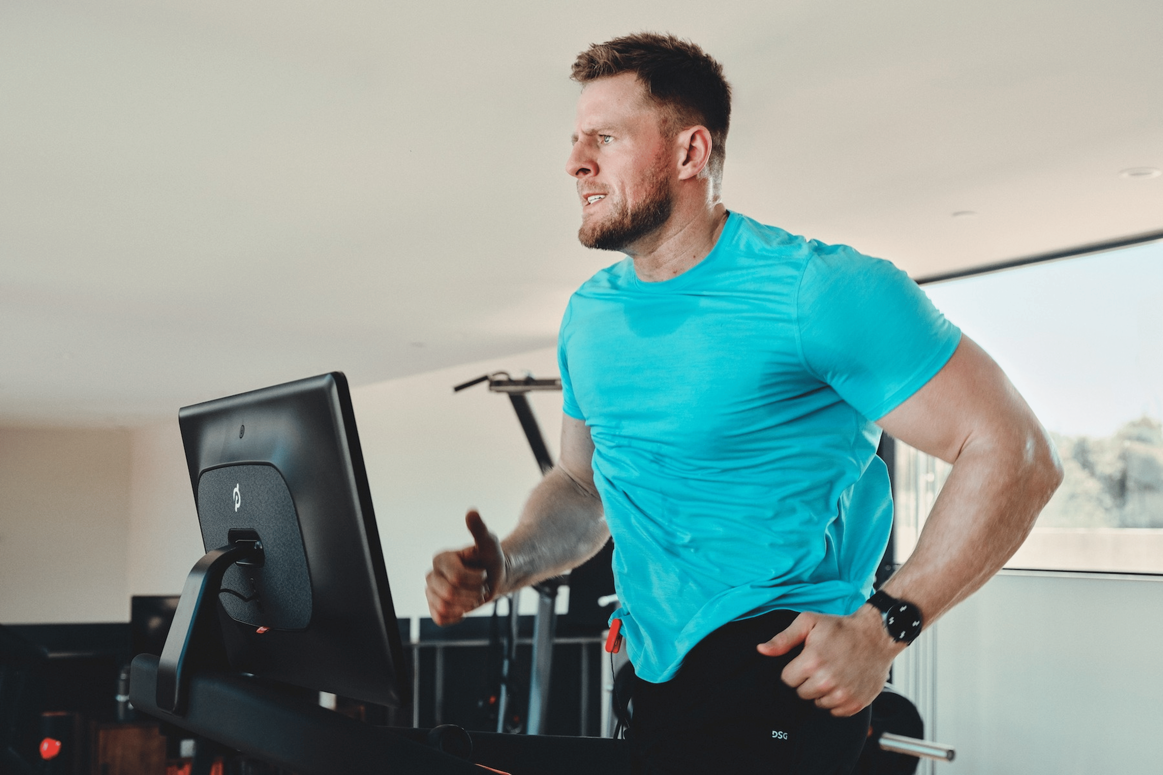 JJ Watt running with intensity on a Peloton Tread.