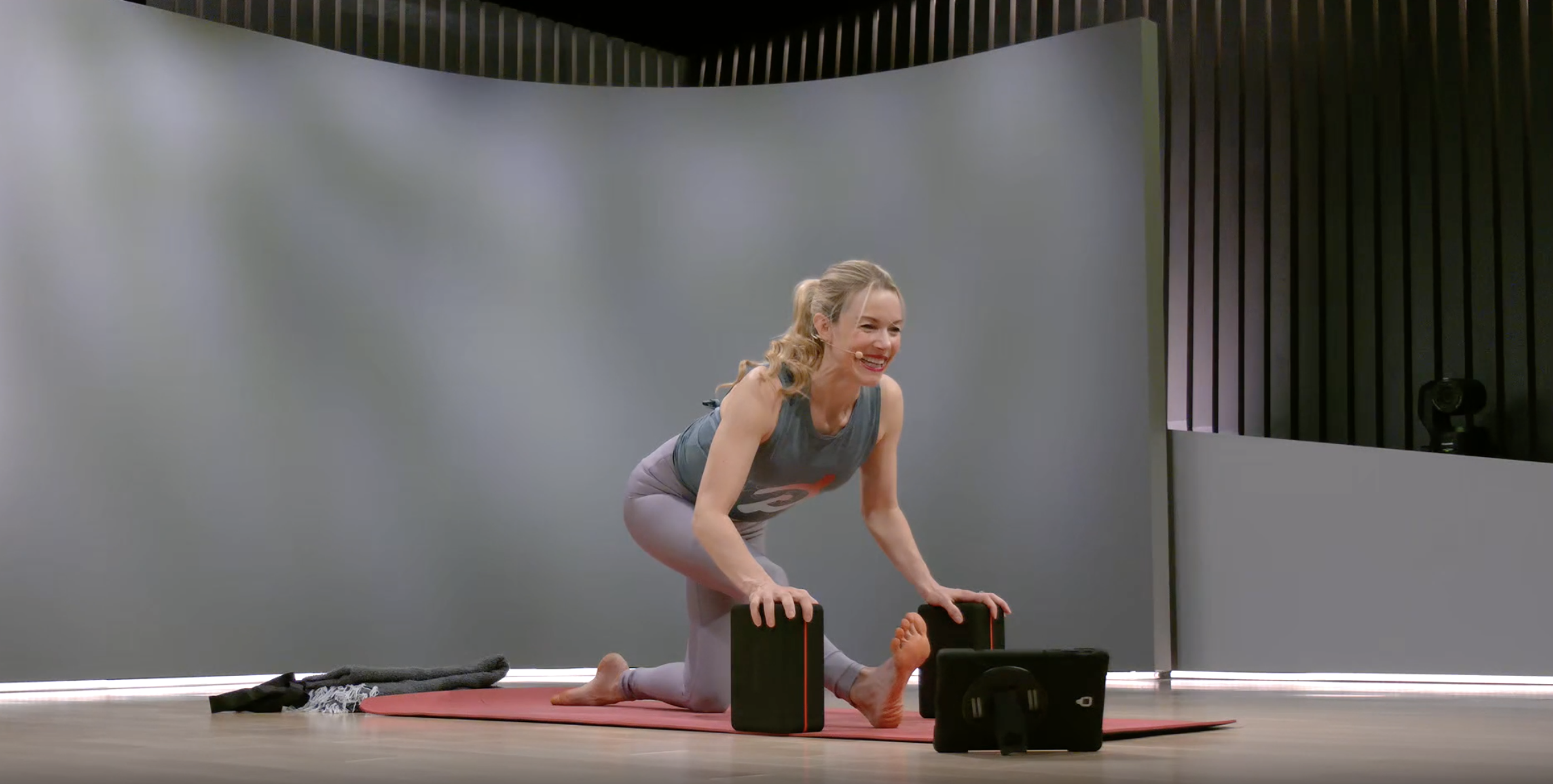 Kristen McGee demonstrates half split supported with yoga blocks 