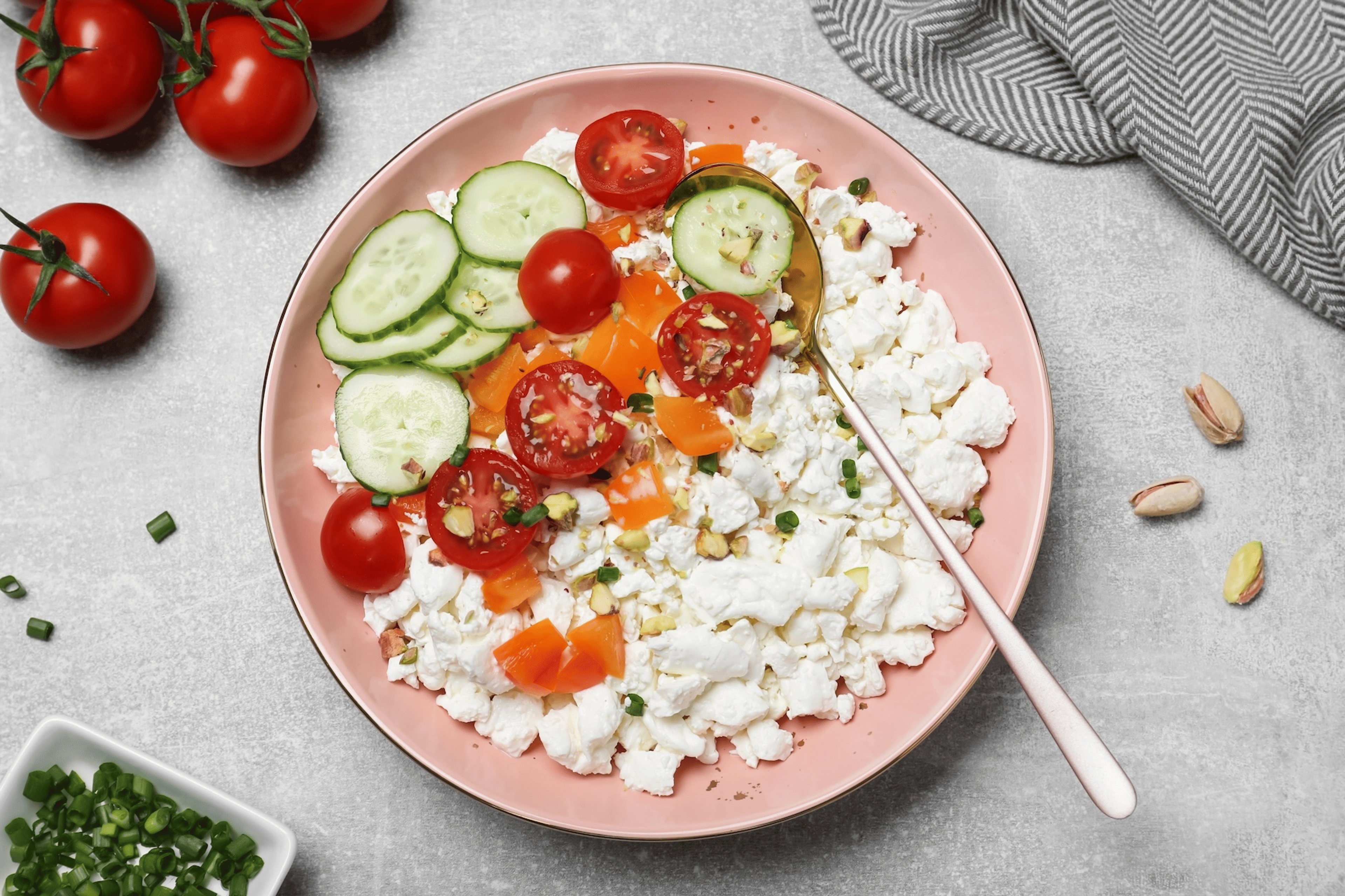 A savory bowl of cottage cheese, a non-meat protein source, with veggies like tomatoes and cucumbers.