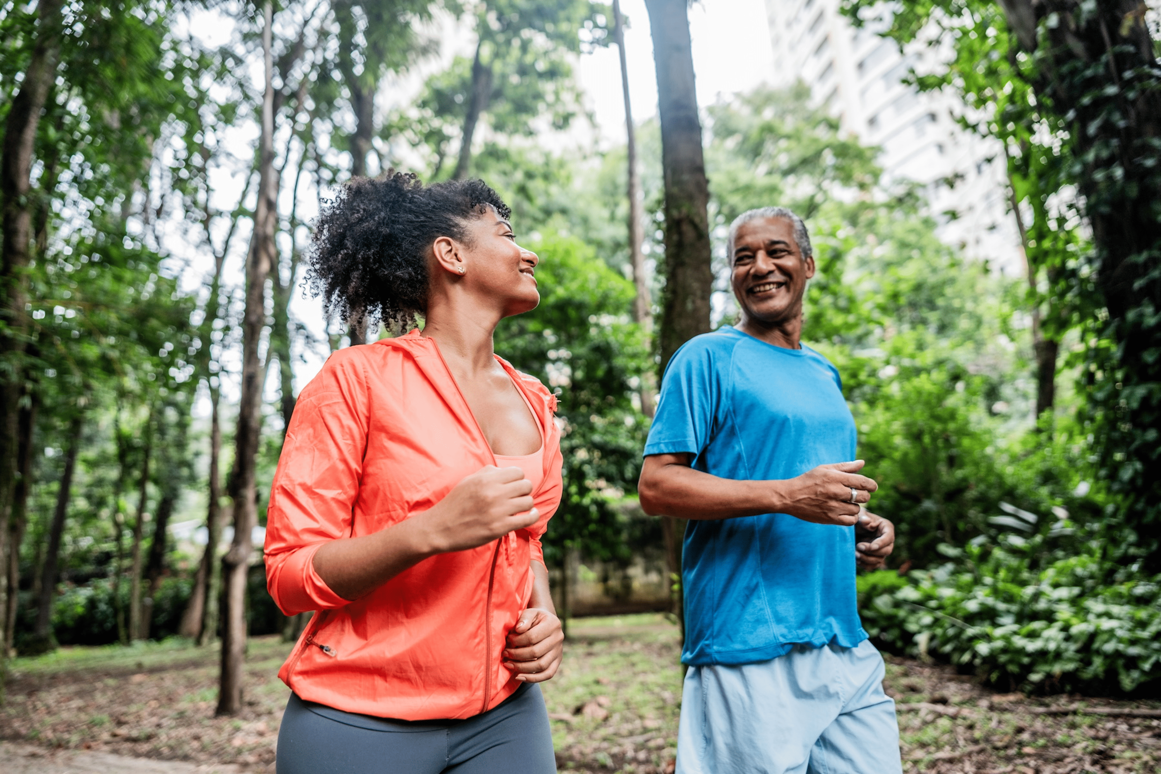A father and daughter going for a walk outdoors to ease lower back pain.