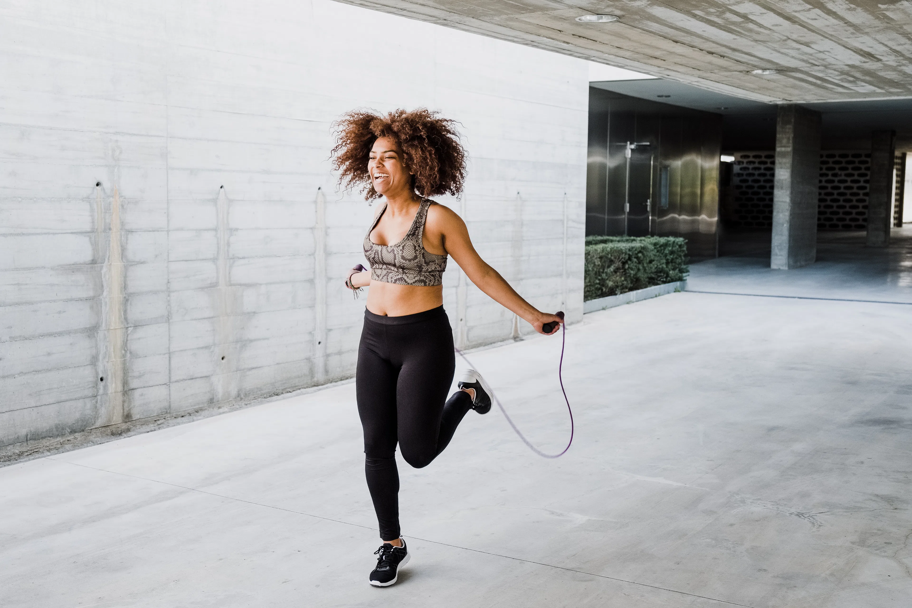 Woman jumping rope outdoors, an example of cardio without running 