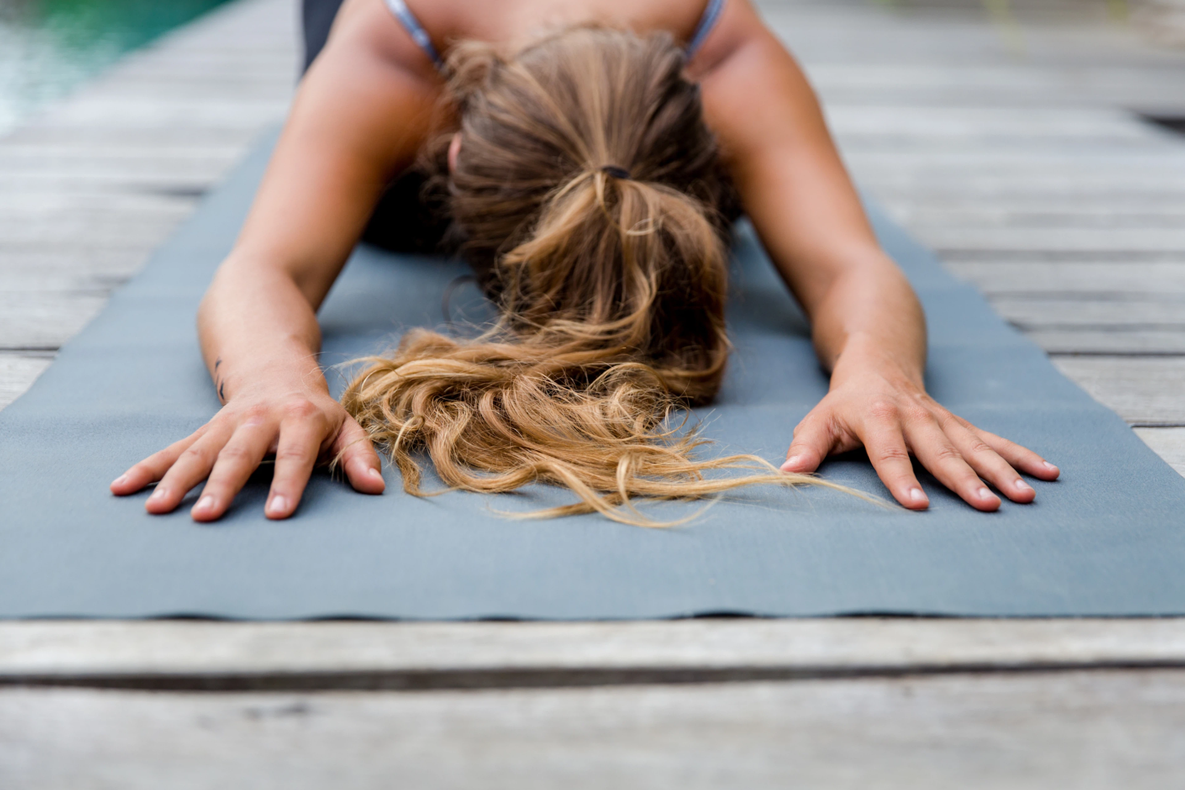 Woman practices Child's Pose (Balasana) in yoga