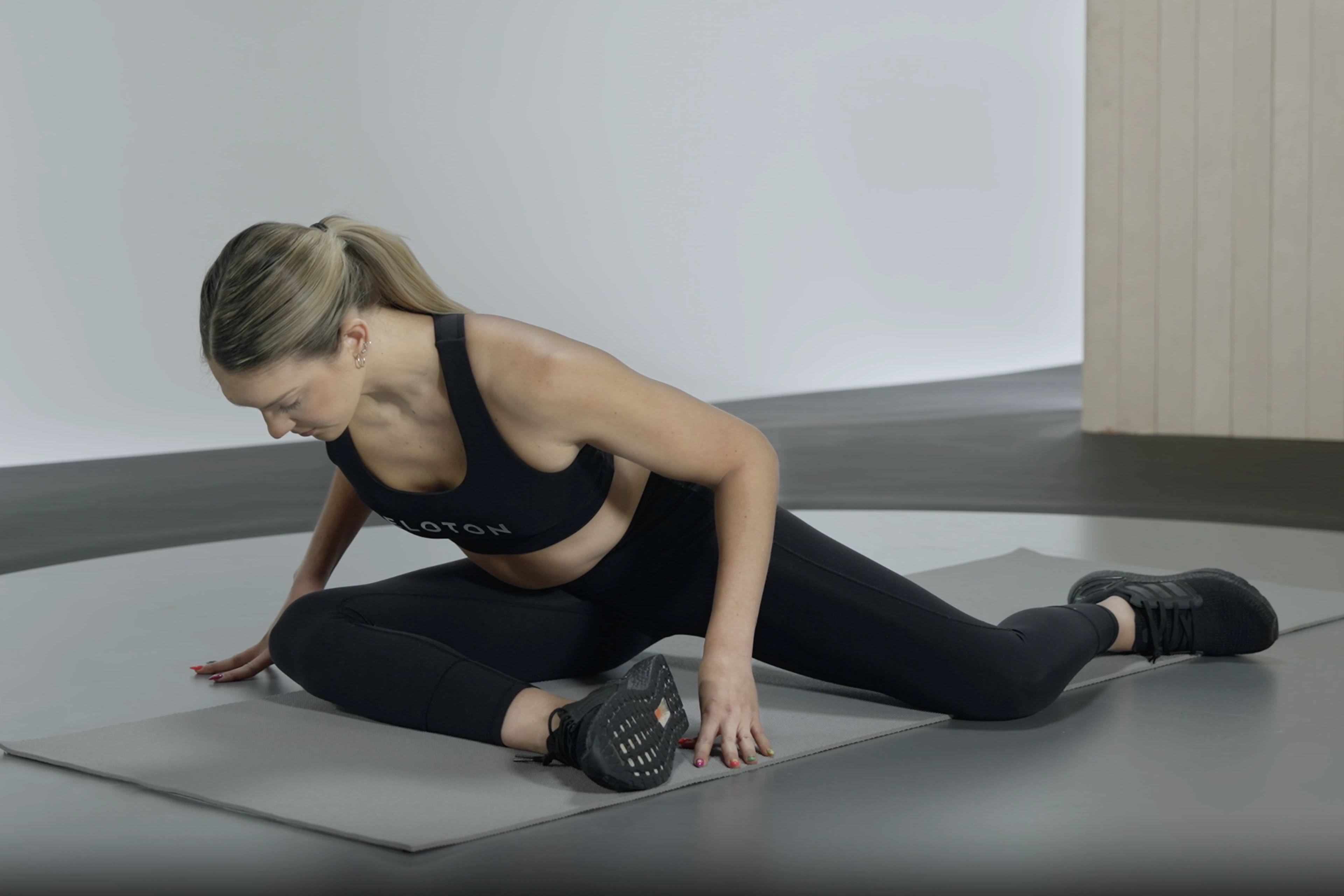 Woman practices the 90/90 hip stretch