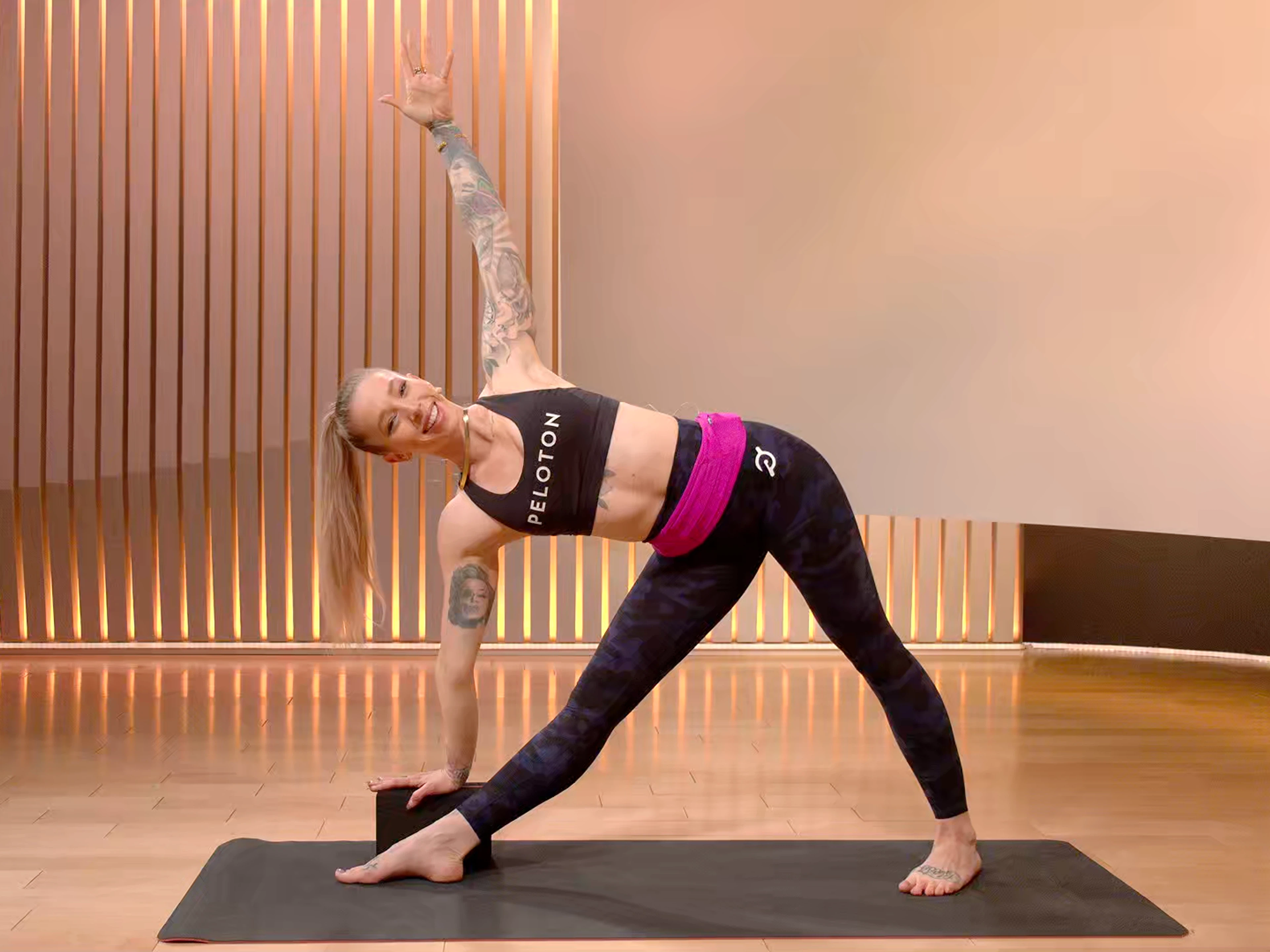 Peloton instructor Kirra Michel doing Triangle Yoga Pose