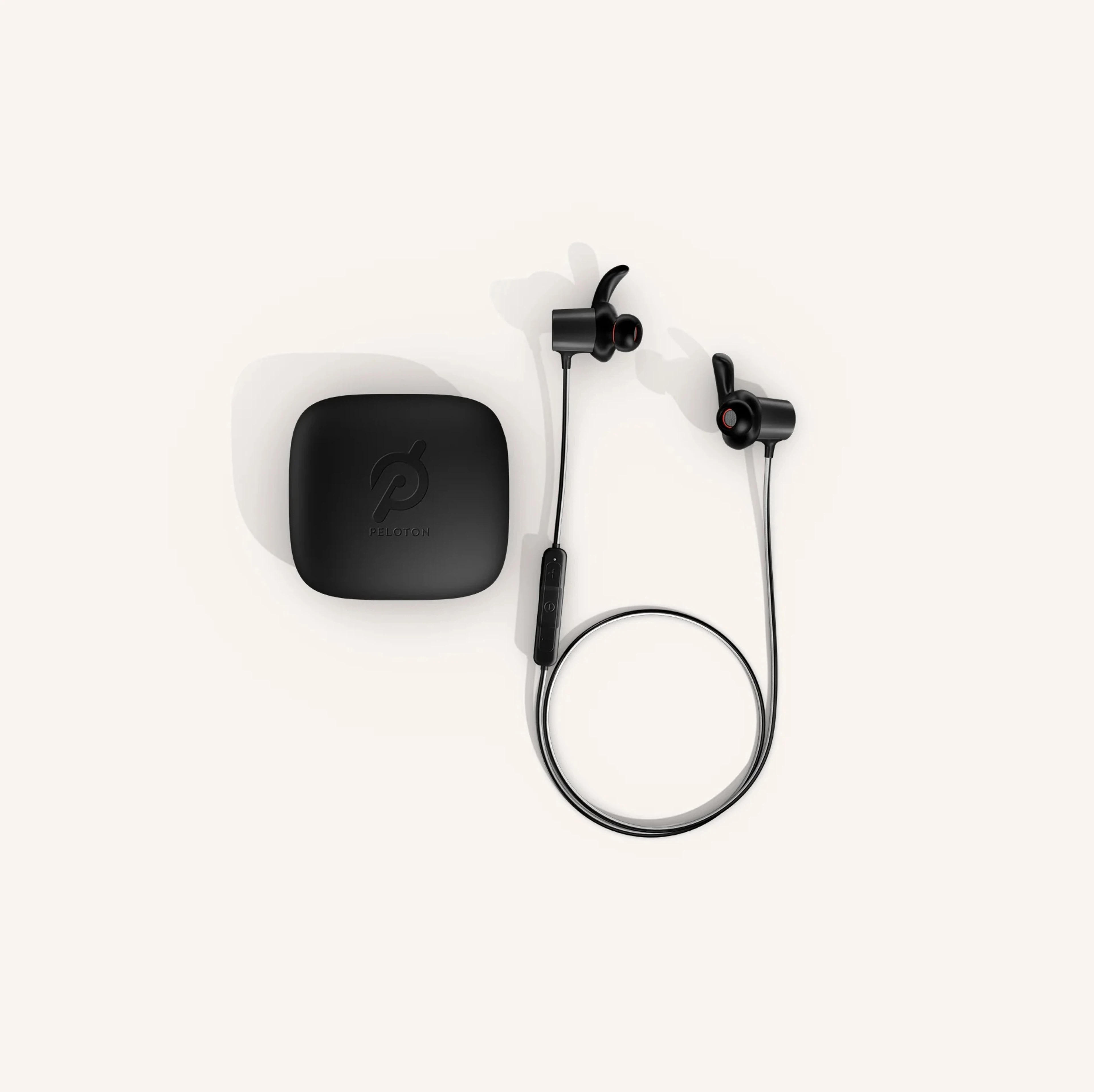 A pair of JBL X Peloton headphones with case as part of a list of Peloton Bike accessories.