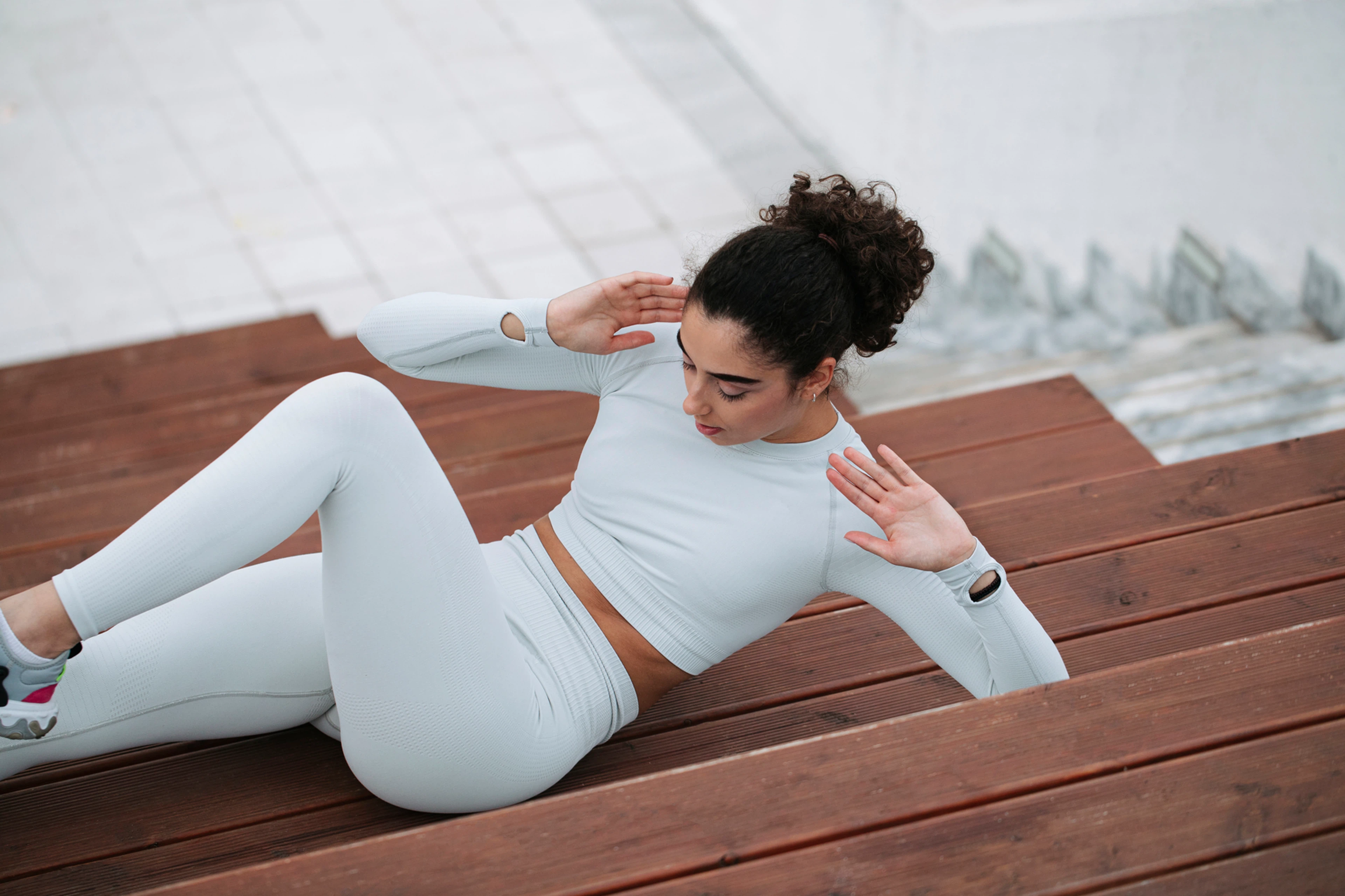 Photo of woman doing bicycle crunches outside