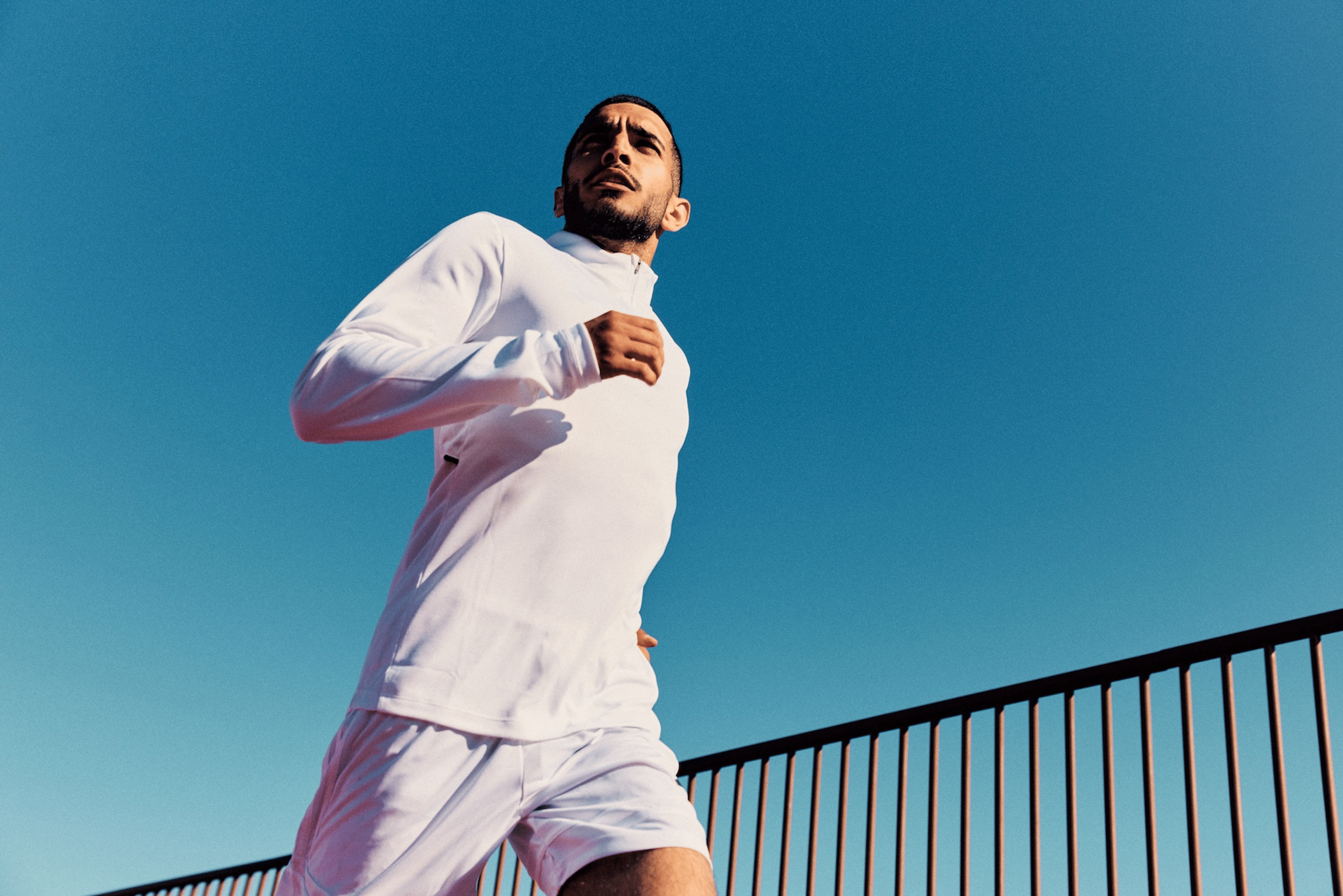 A young man going for a run on a clear sunny day.