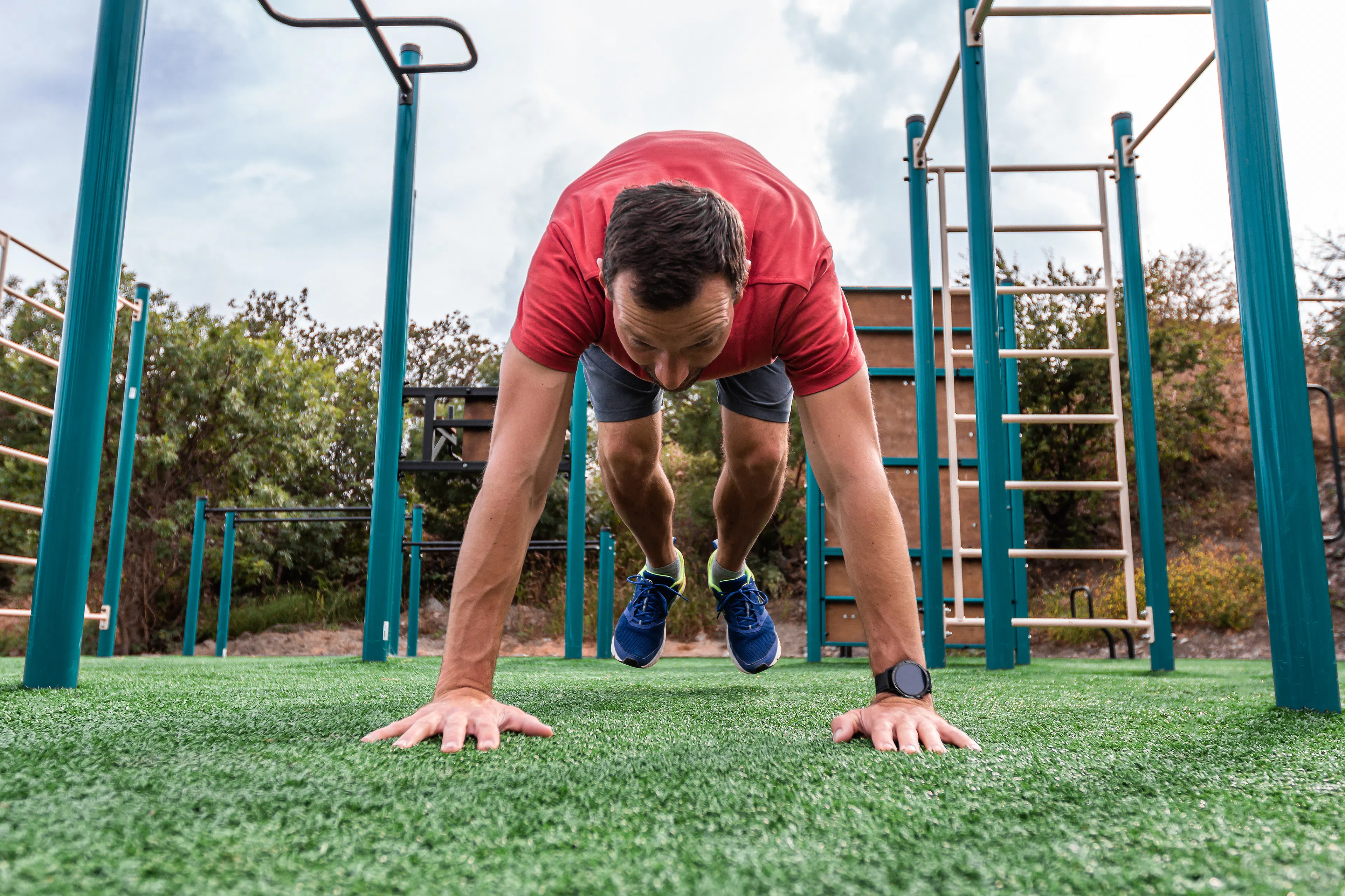 Man does a burpee exercise outdoors