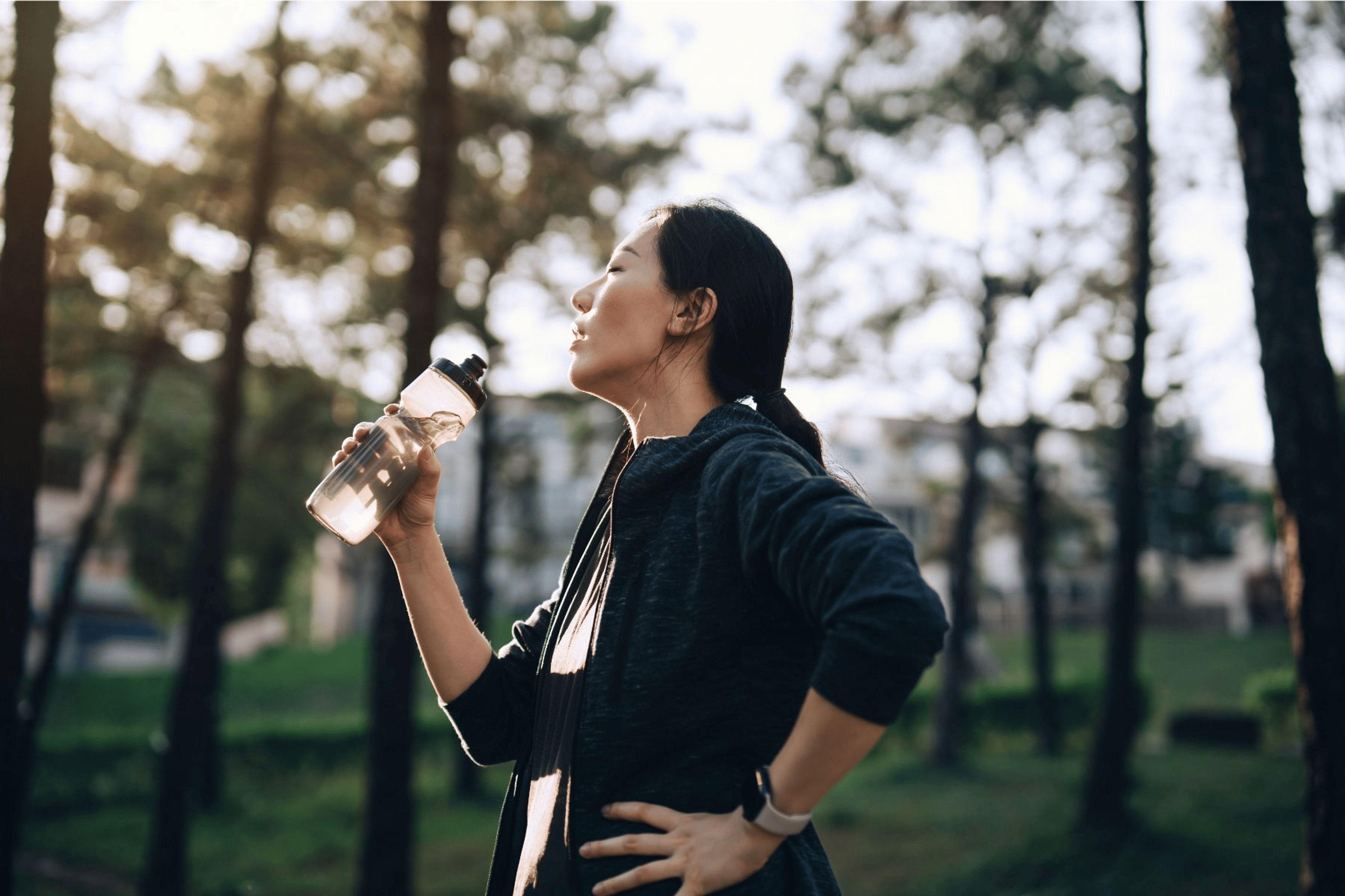 Woman drinking water after a workout outside