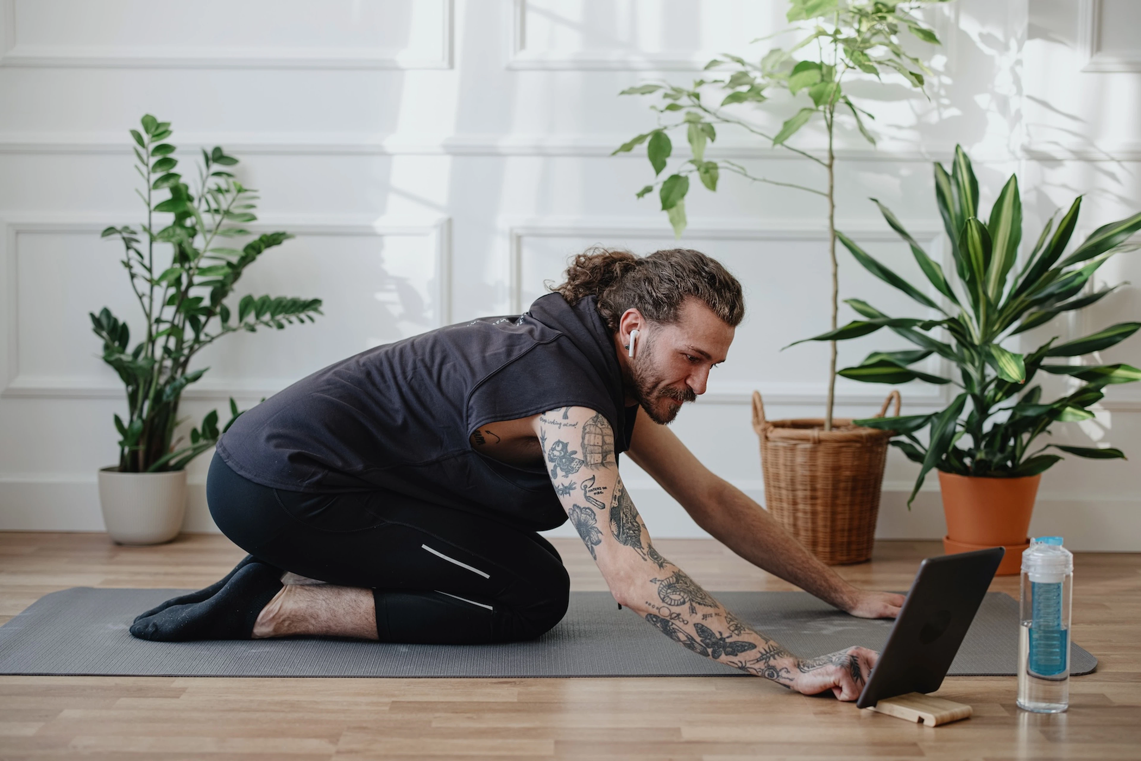 A man preparing to do some restorative yoga at home as he takes a week off of working out.