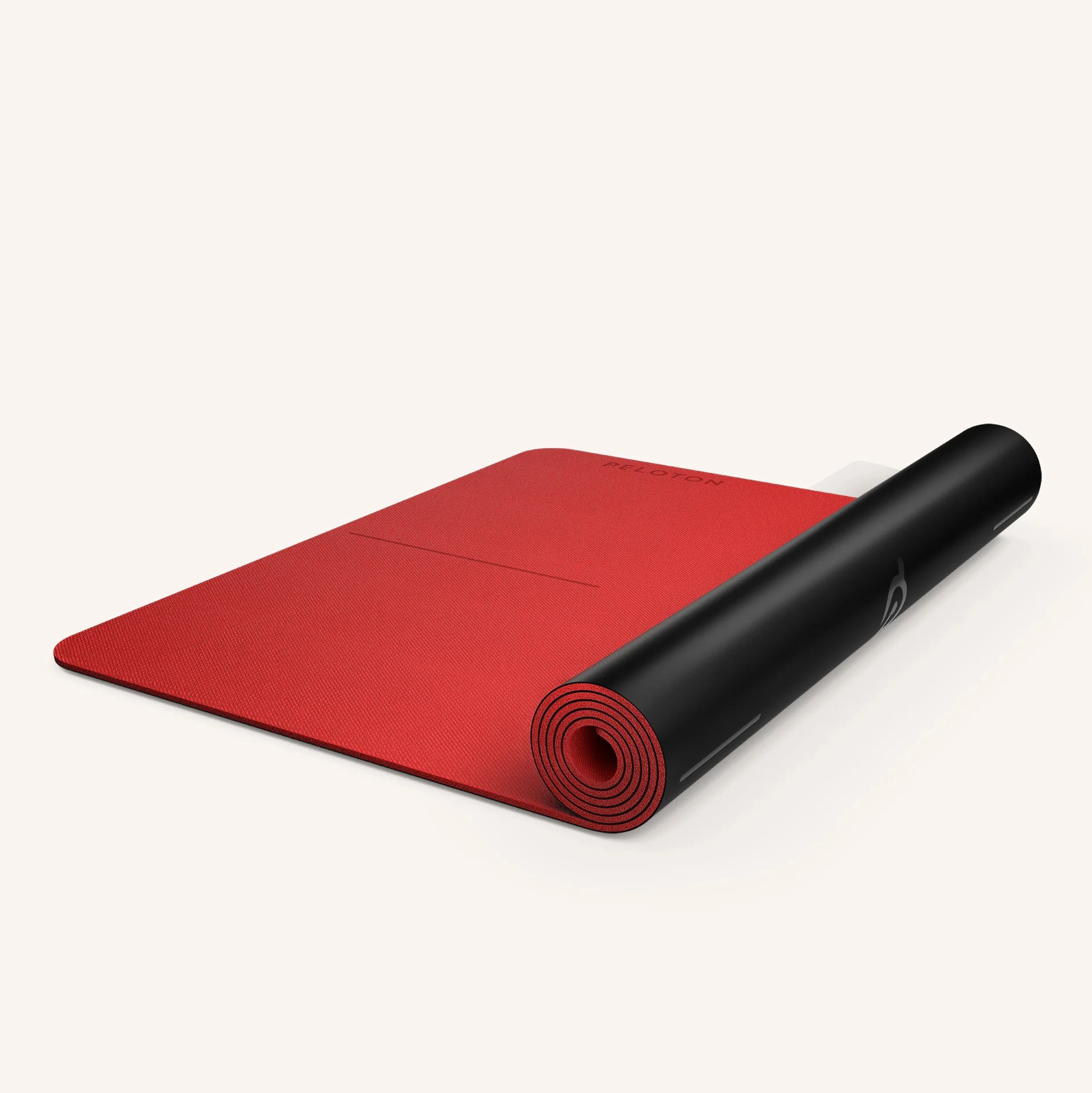 A reversible red and black Peloton workout mat as part of a list of Peloton Bike accessories.