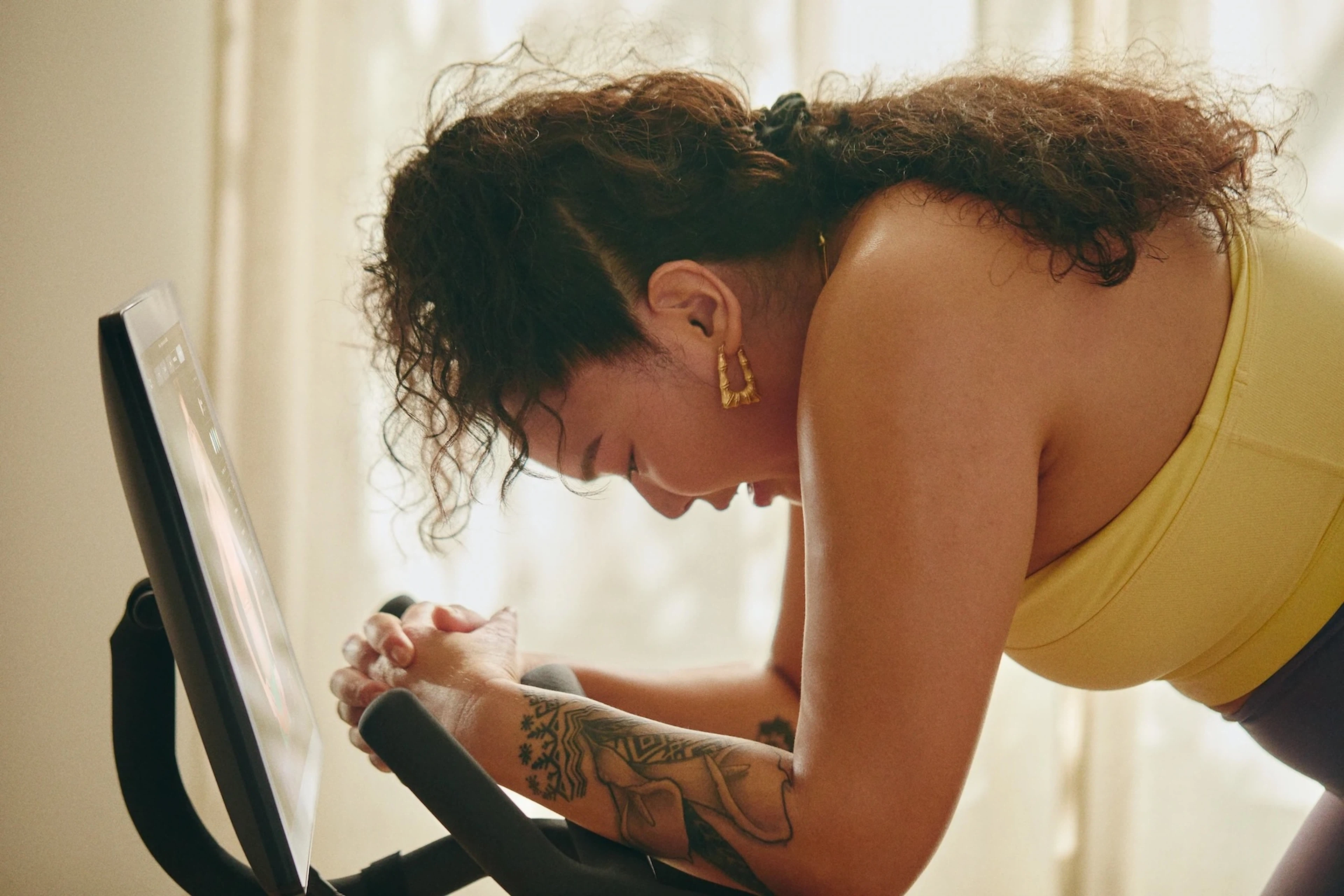 Woman working on her mindset as she takes a Peloton class