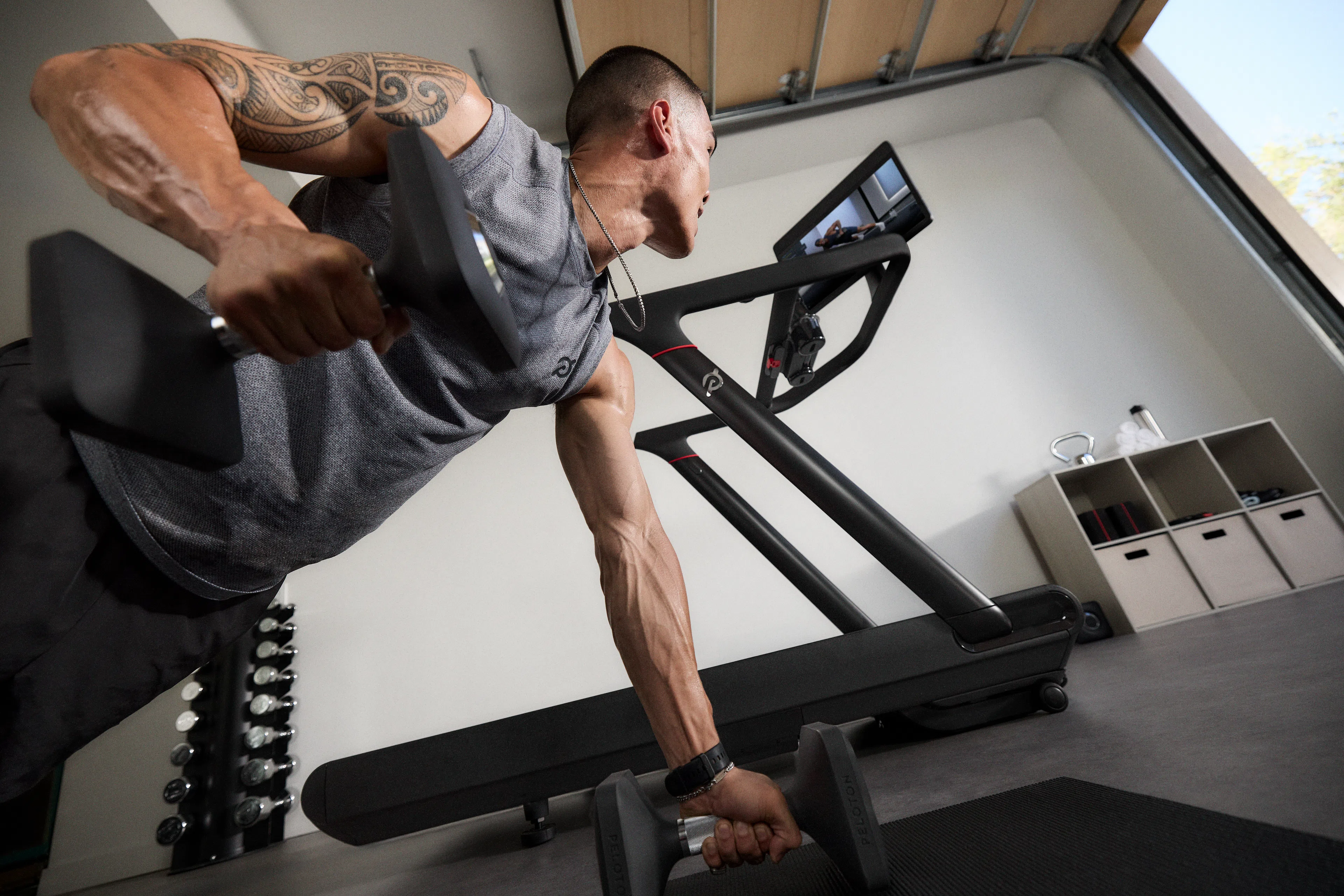 Man doing a Bike Bootcamp workout class at home using a Peloton Tread.