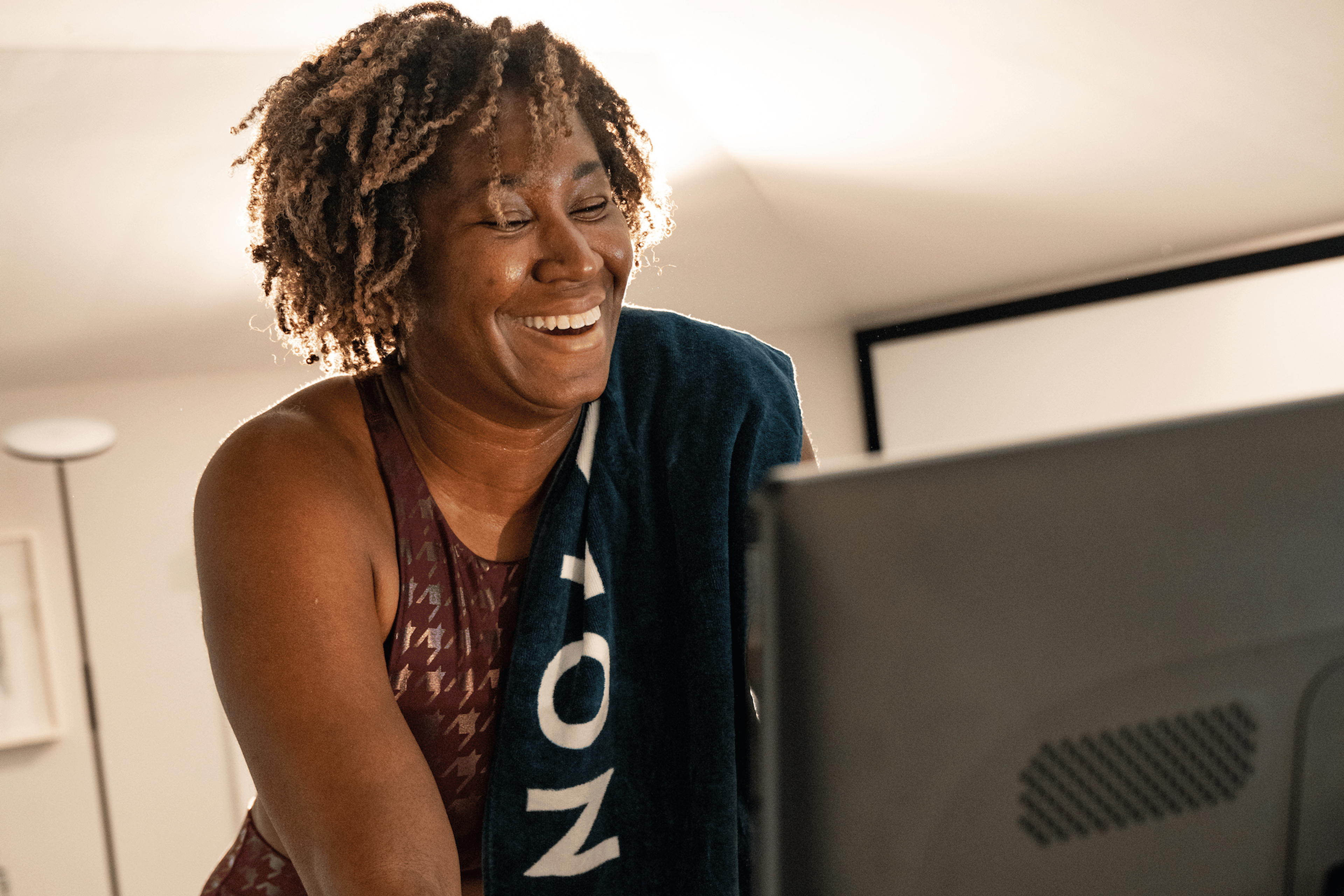Smiling woman on a Peloton Bike 