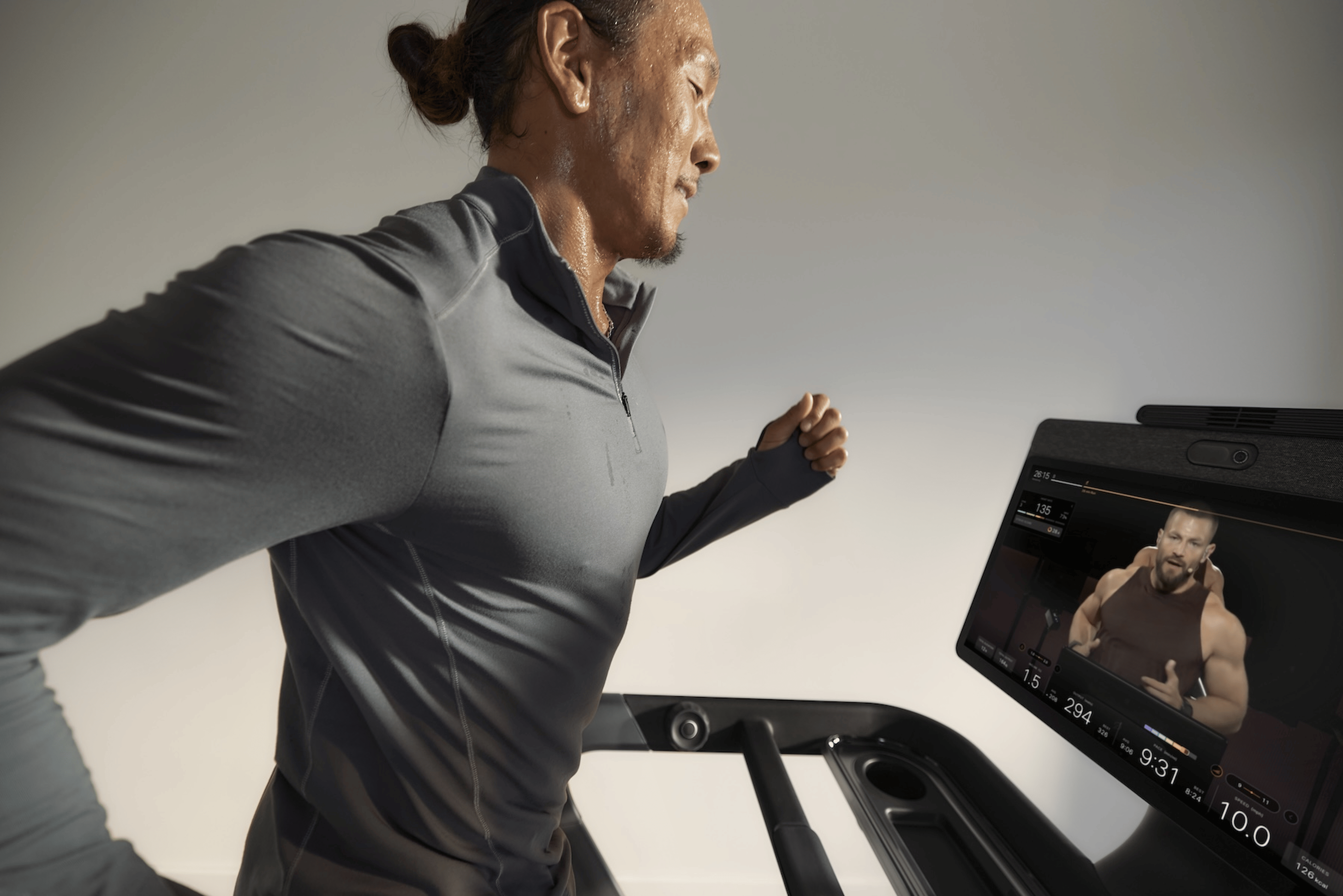 A man doing a running workout on the Peloton Cross Training Series Tread+ Powered By Peloton IQ.