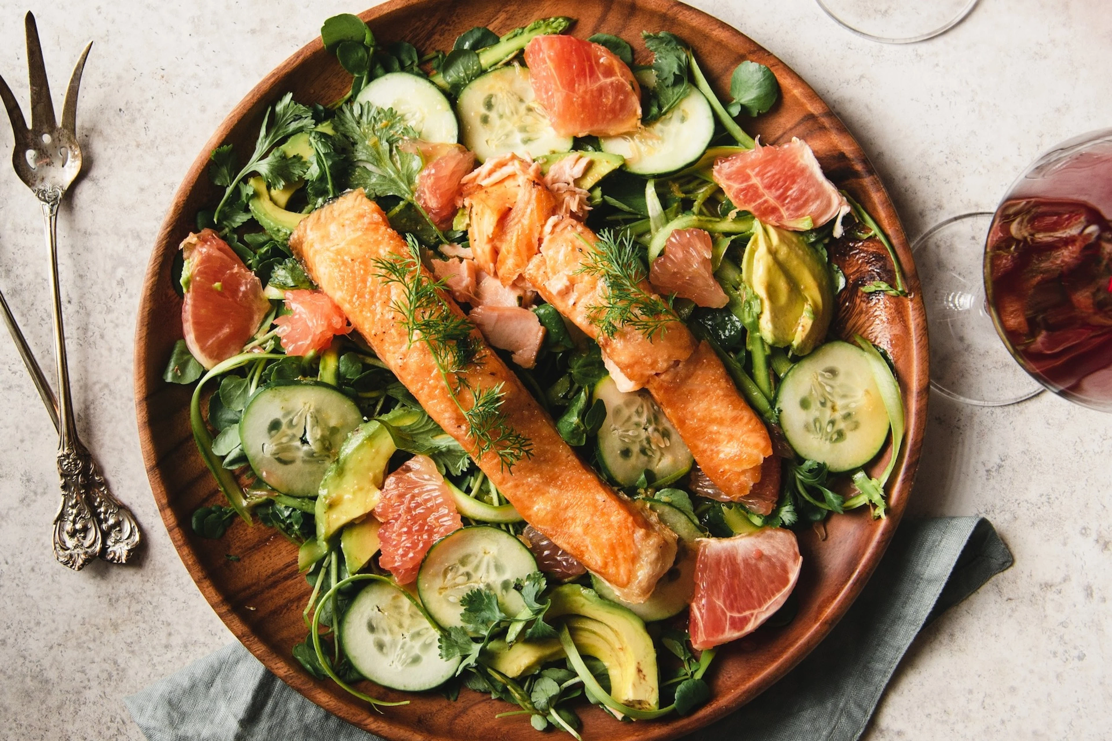 An aerial view of a healthy watercress salad with salmon.