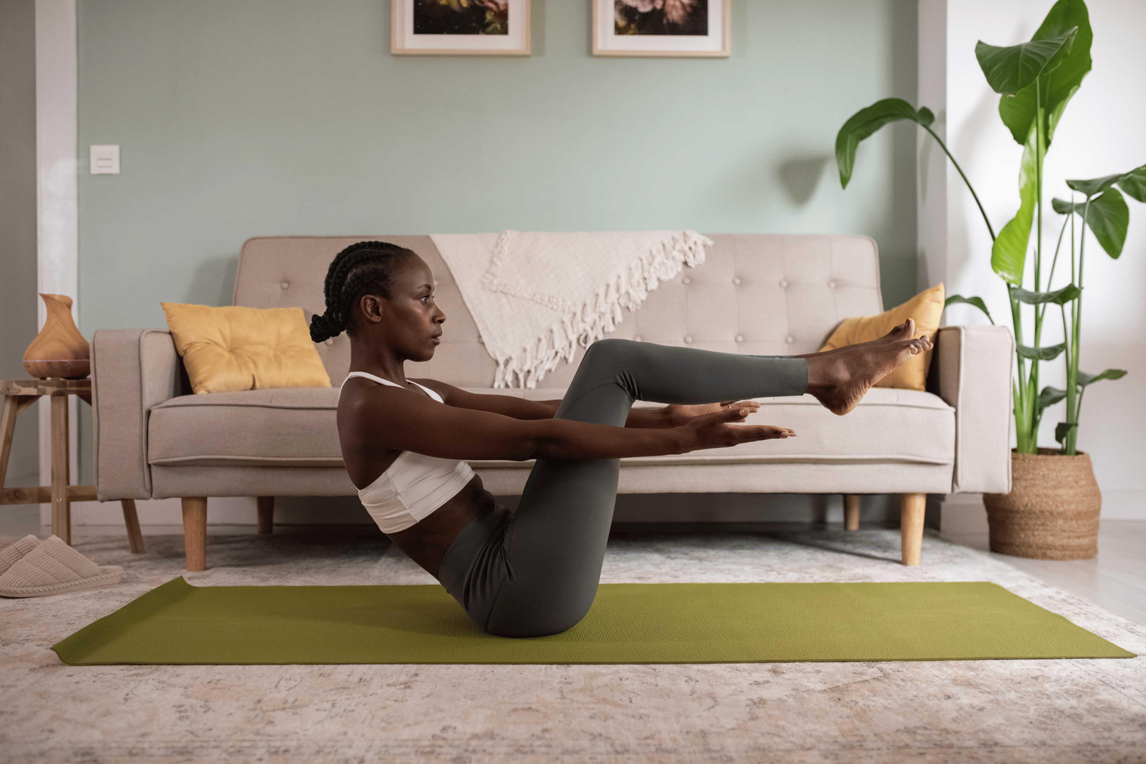 Woman doing half boat pose