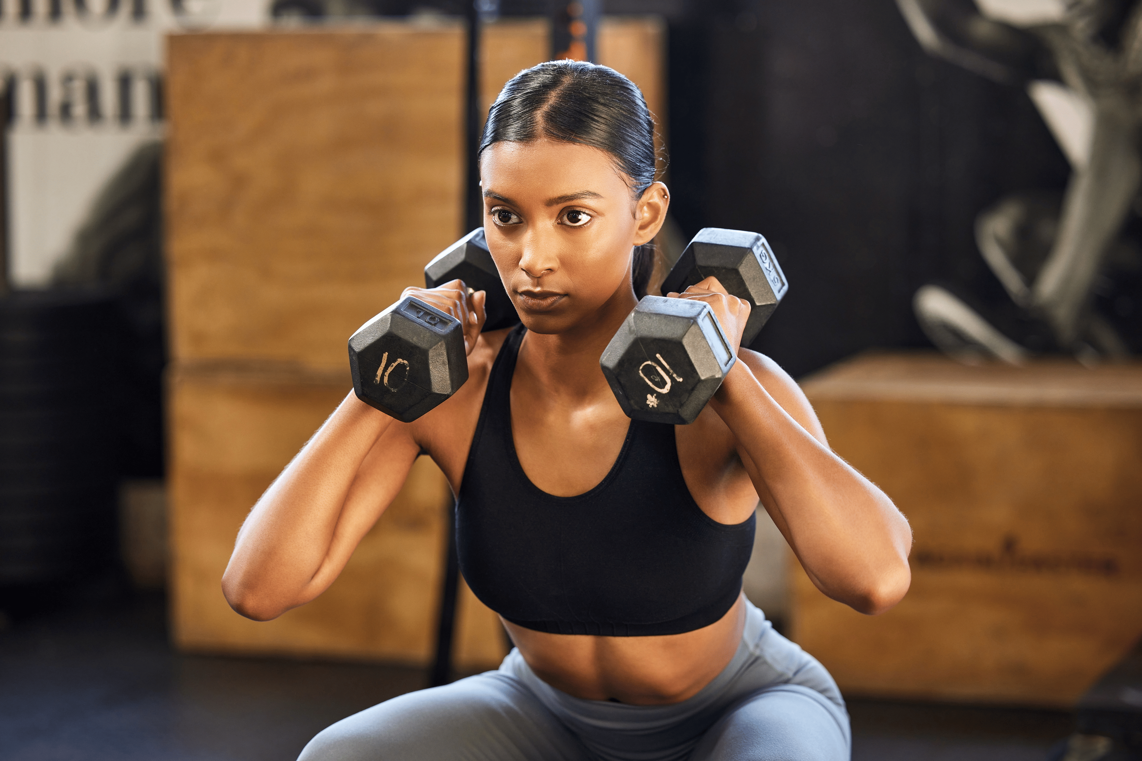 Woman lifting weights at gym