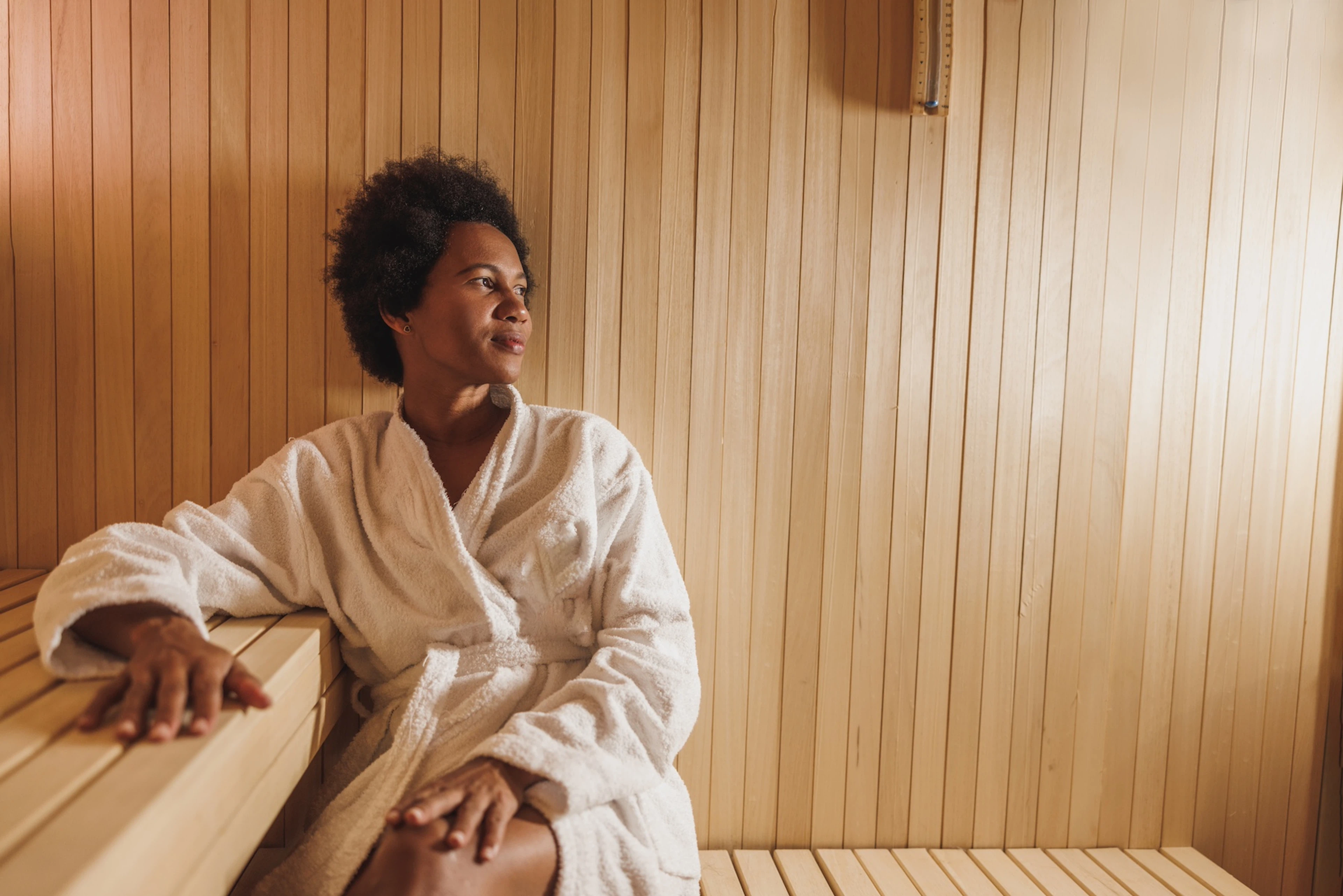 A woman relaxing in the sauna after a workout. 