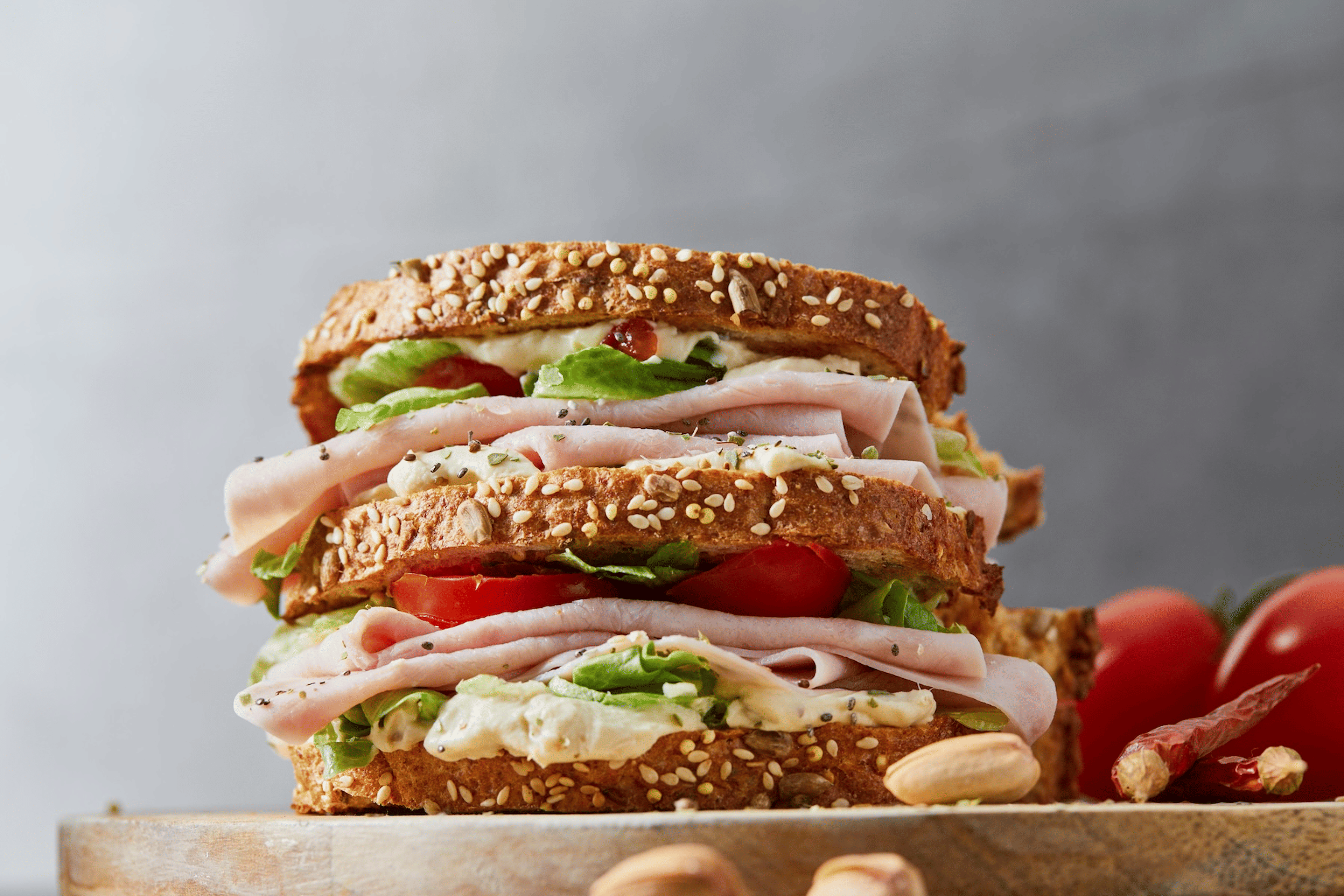 A turkey sandwich with veggies and other toppings.