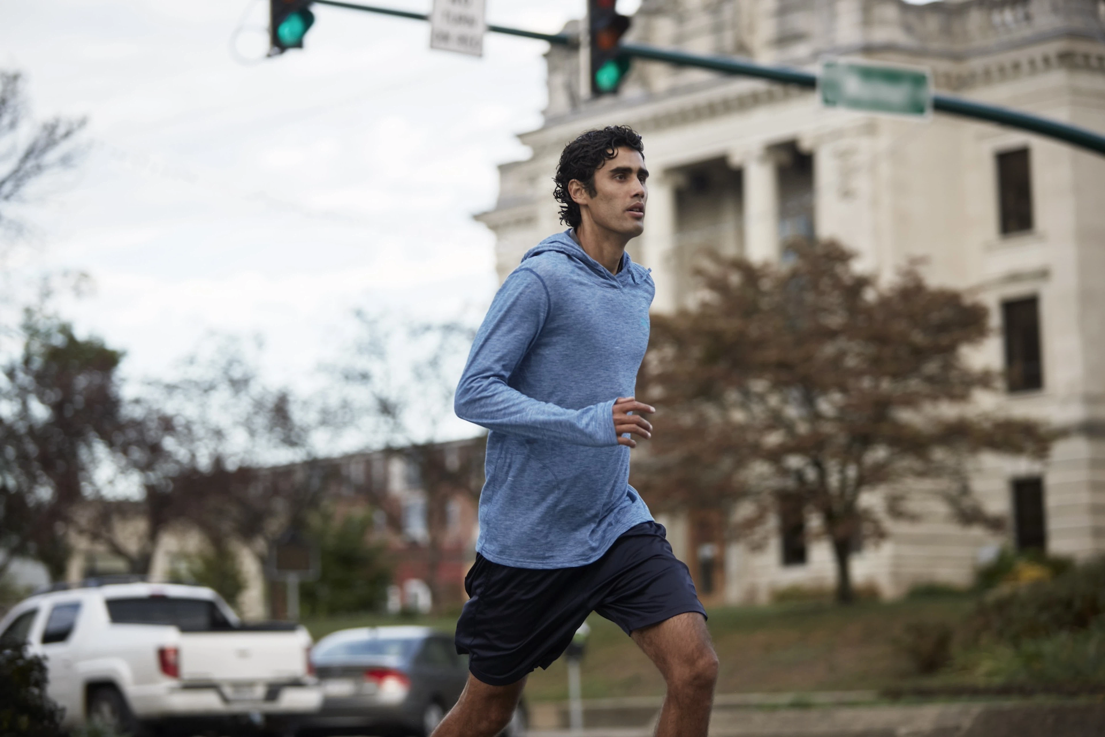 A man practicing discipline by going on a jog through the city.