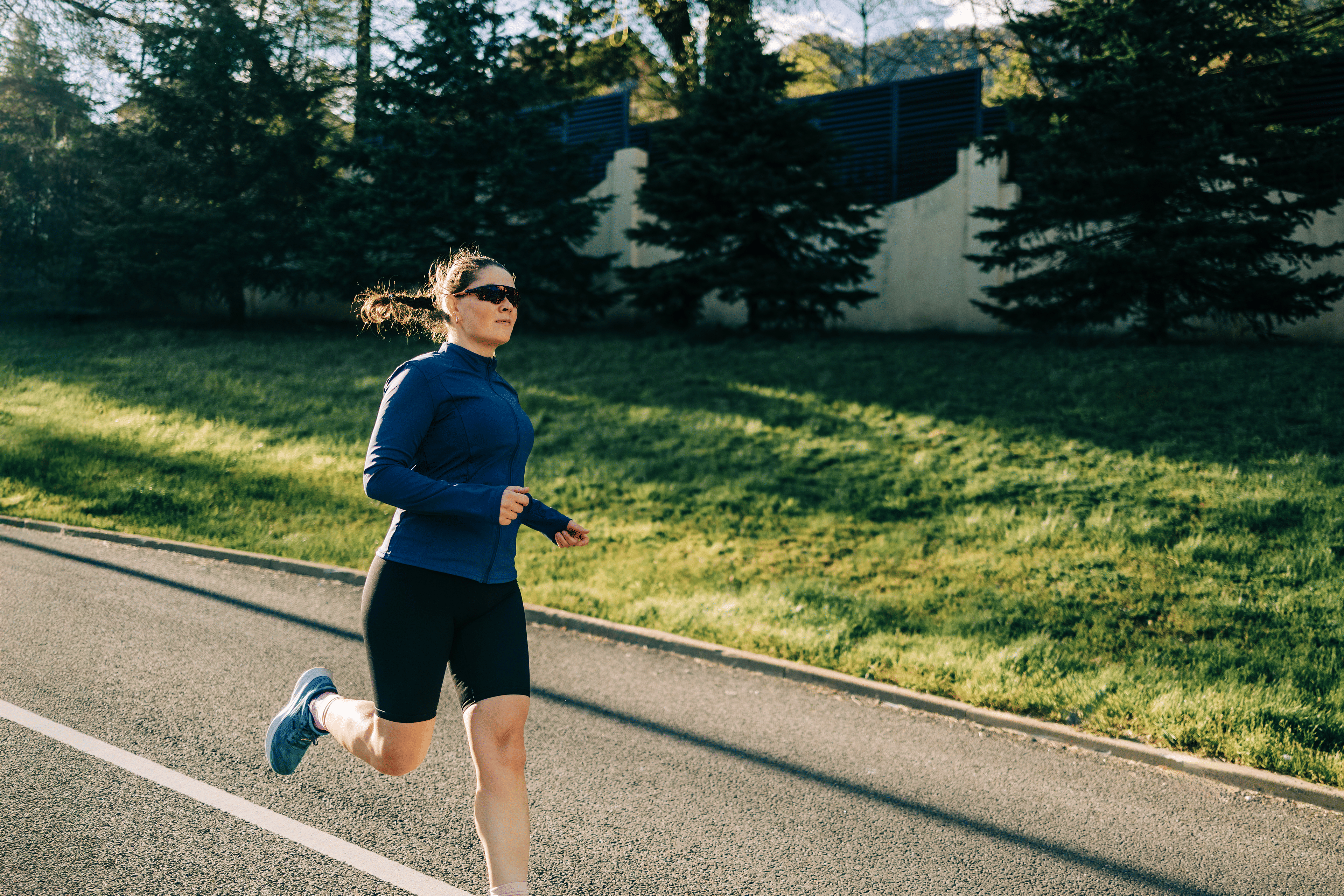 Woman practicing how to stop overstriding while runing outside.