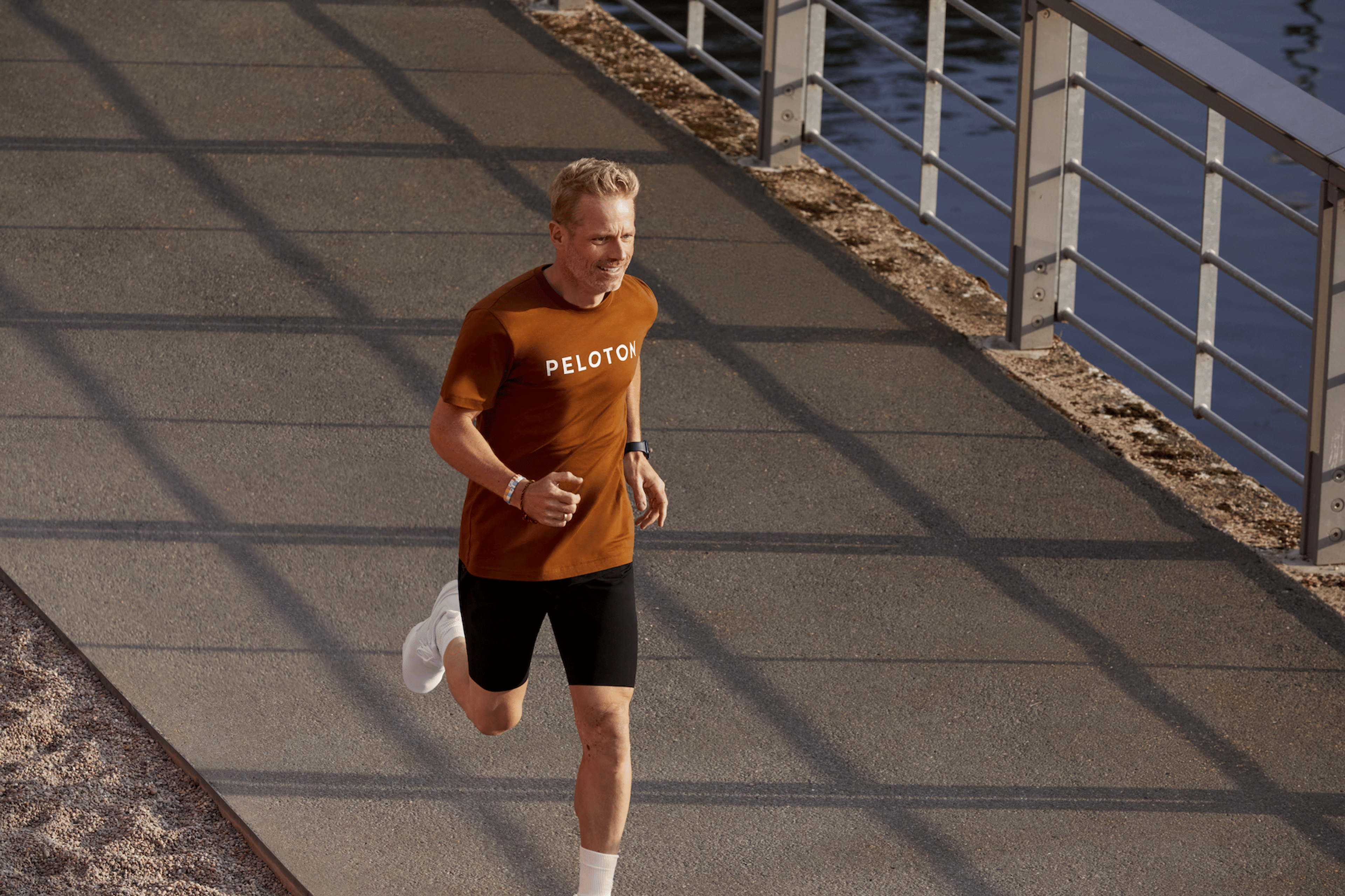 Person in a Peloton T-shirt running while working on proper running form.
