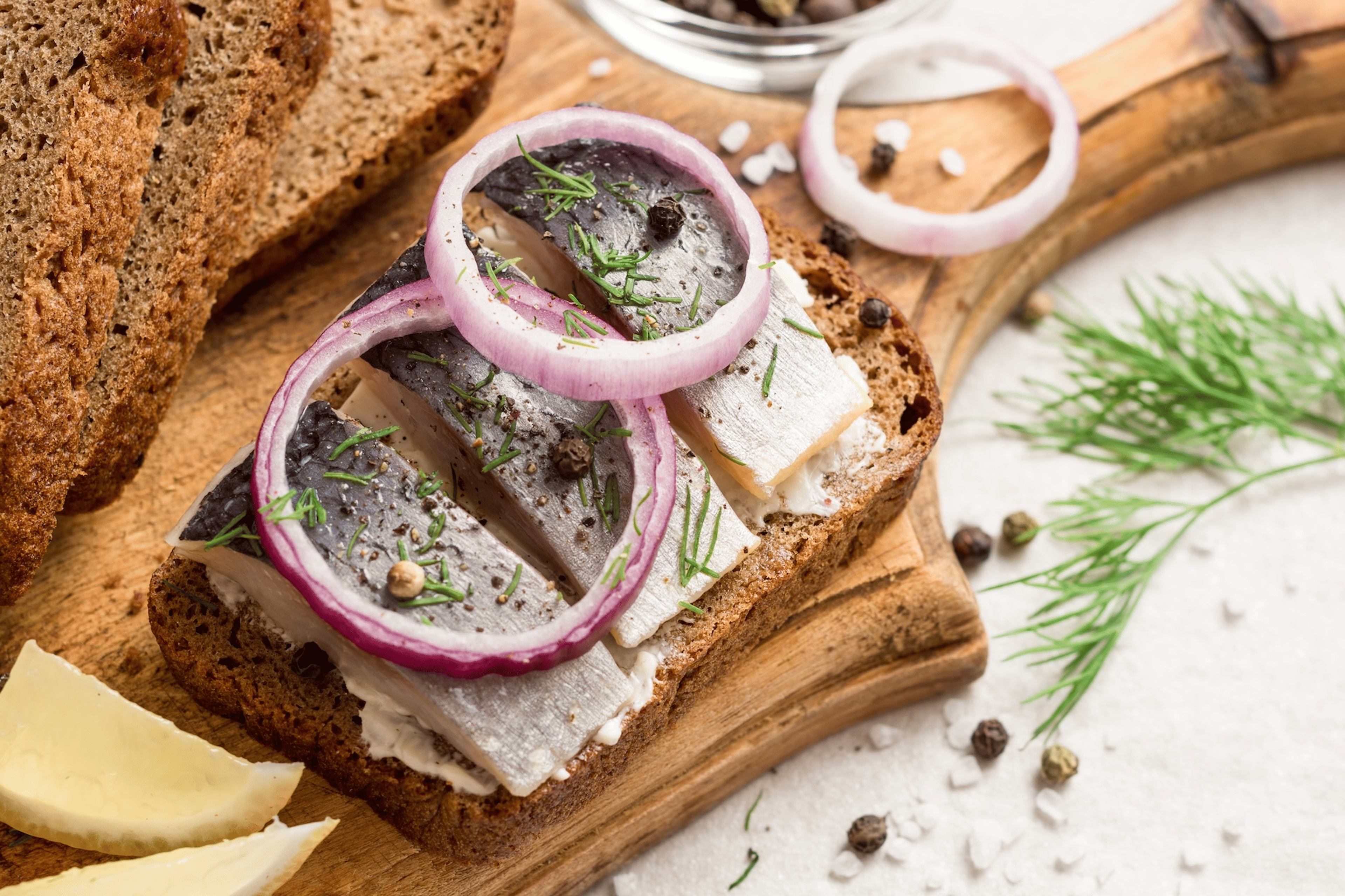 A slice of toast with herring (a creatine-rich food) and red onions and capers.