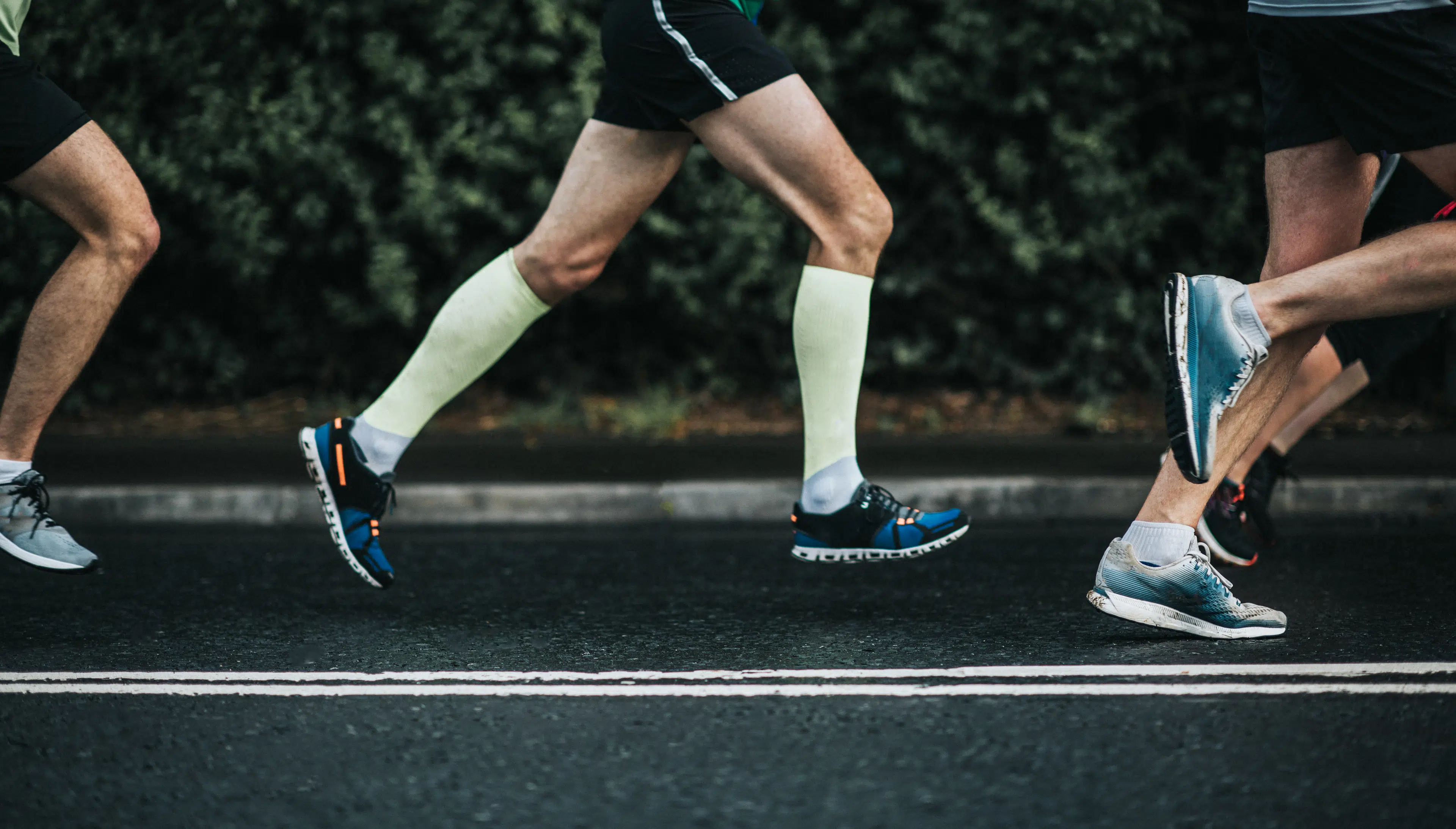 Runners' legs on a road training to improve running economy