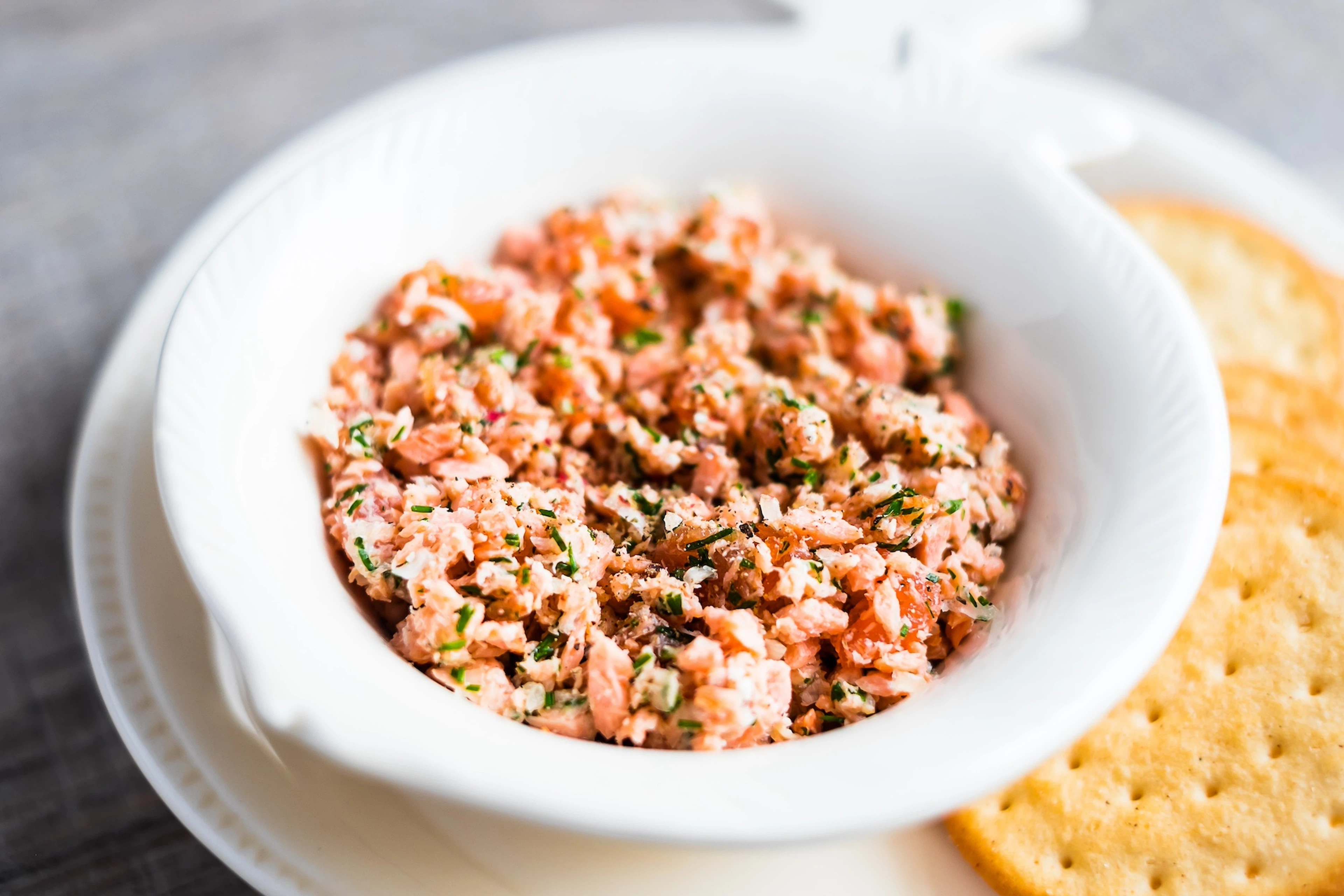 A bowl of salmon made into a dip-like dish. Salmon is a high-protein snack.