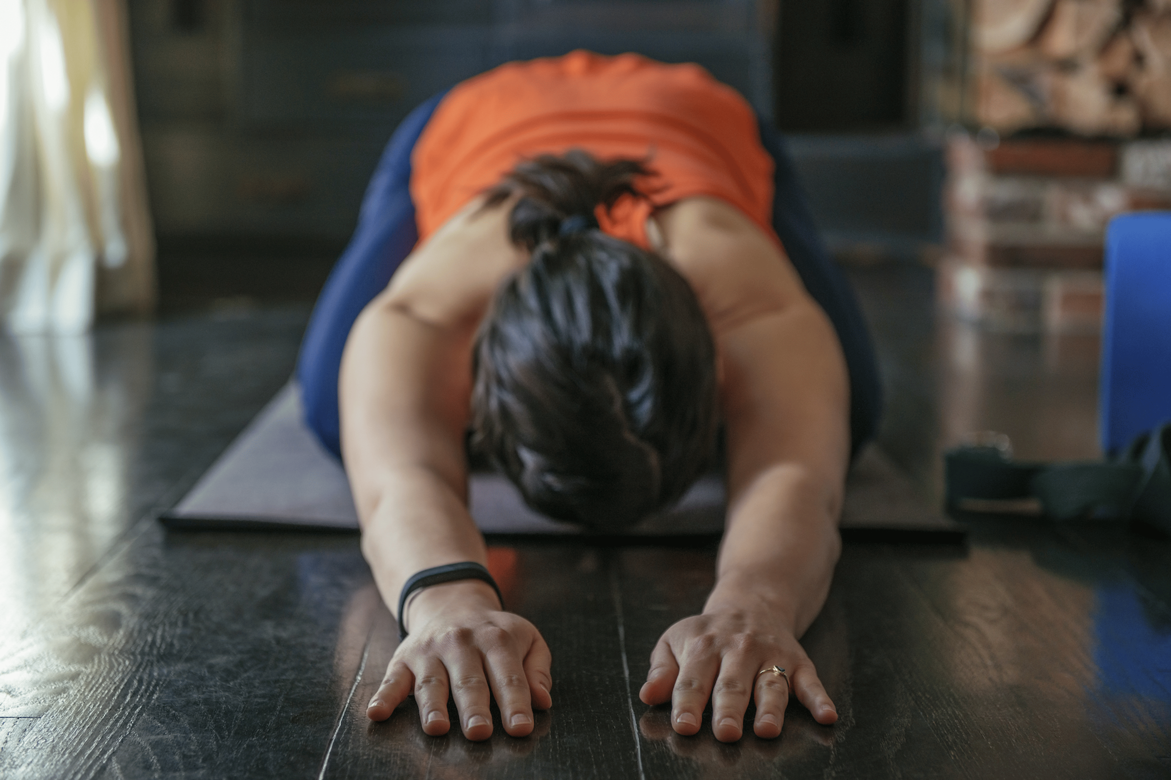 Woman practices Child's Pose, yoga for runners