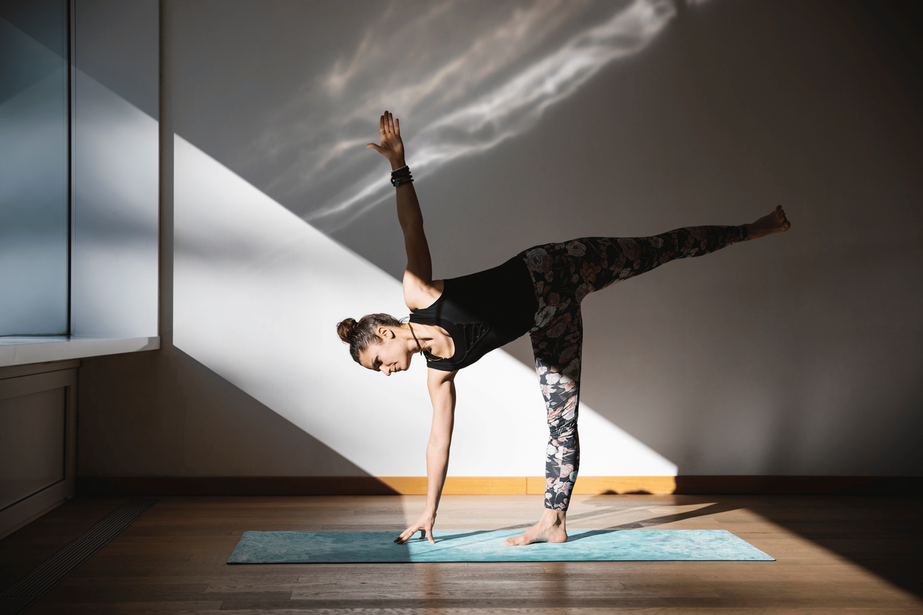 Woman practices half moon pose during a yoga practice