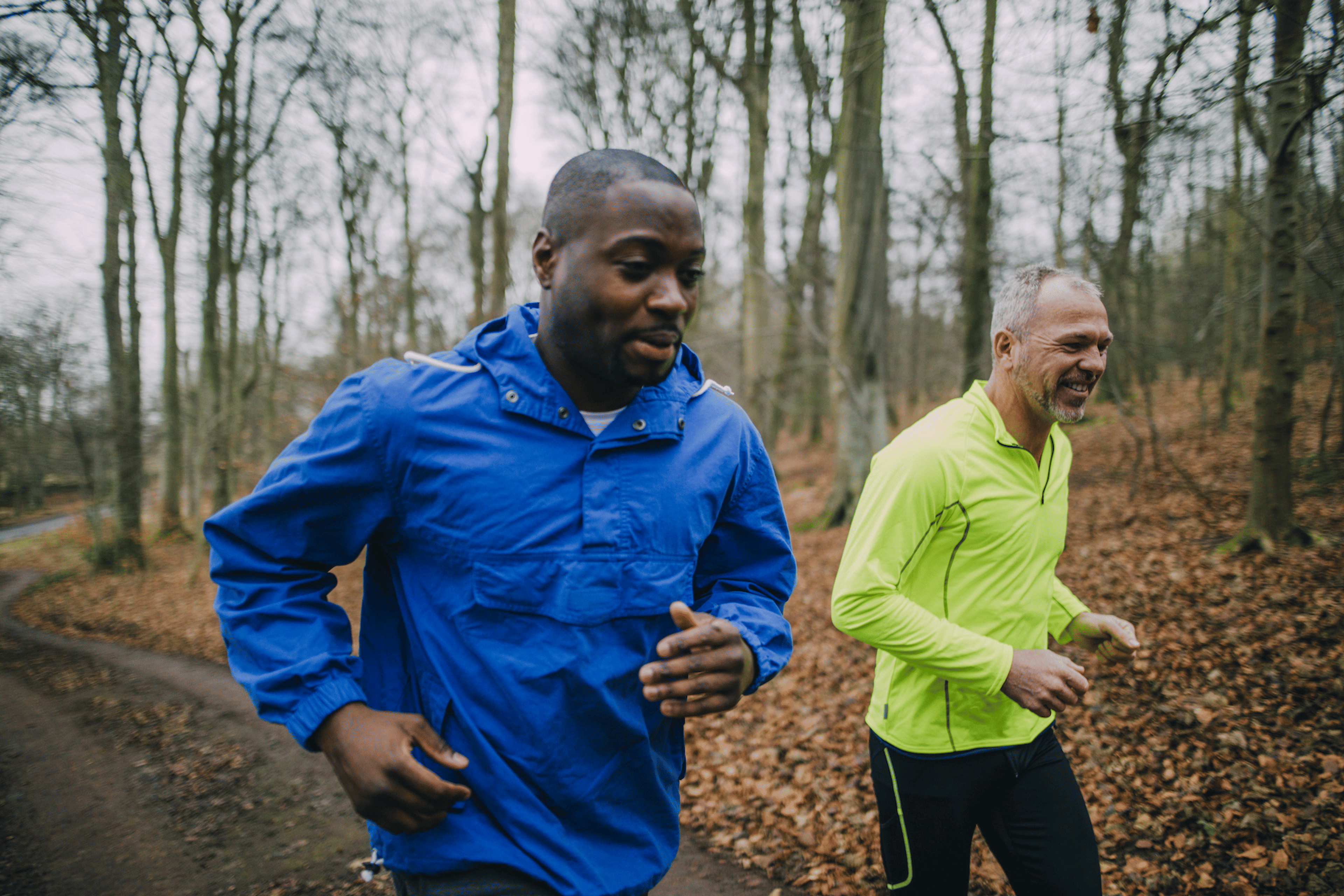 Two men running outside on a trail