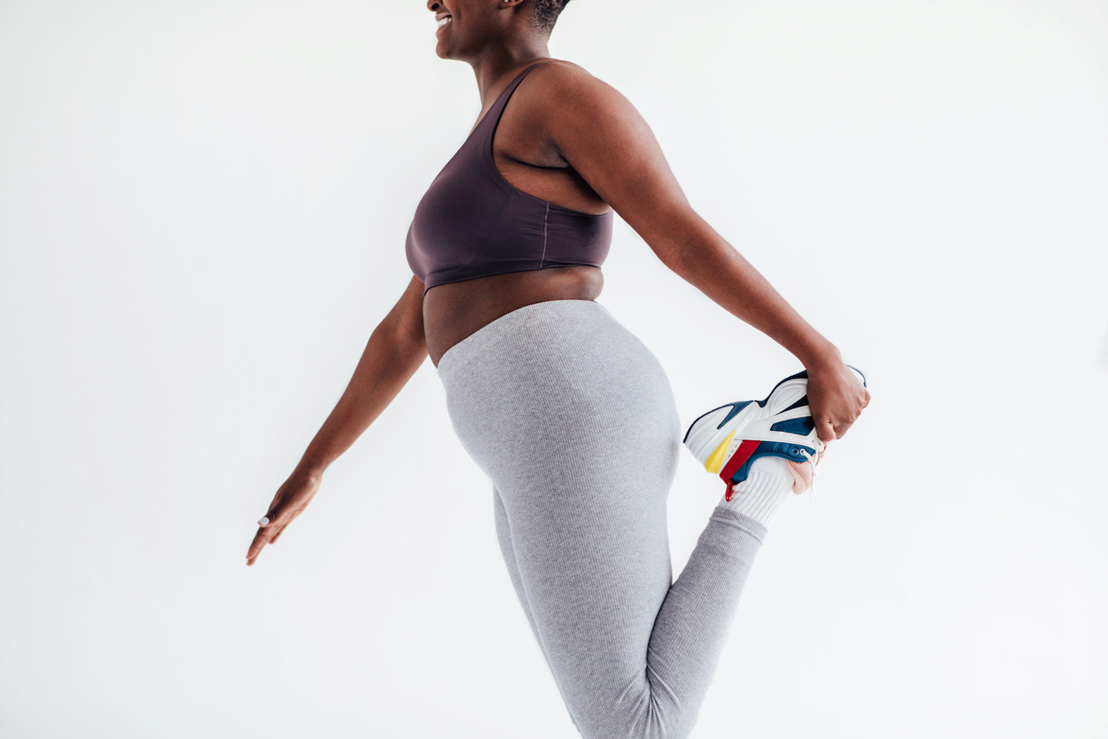 A young woman stretching her leg. Stretching is a key part of injury prevention.