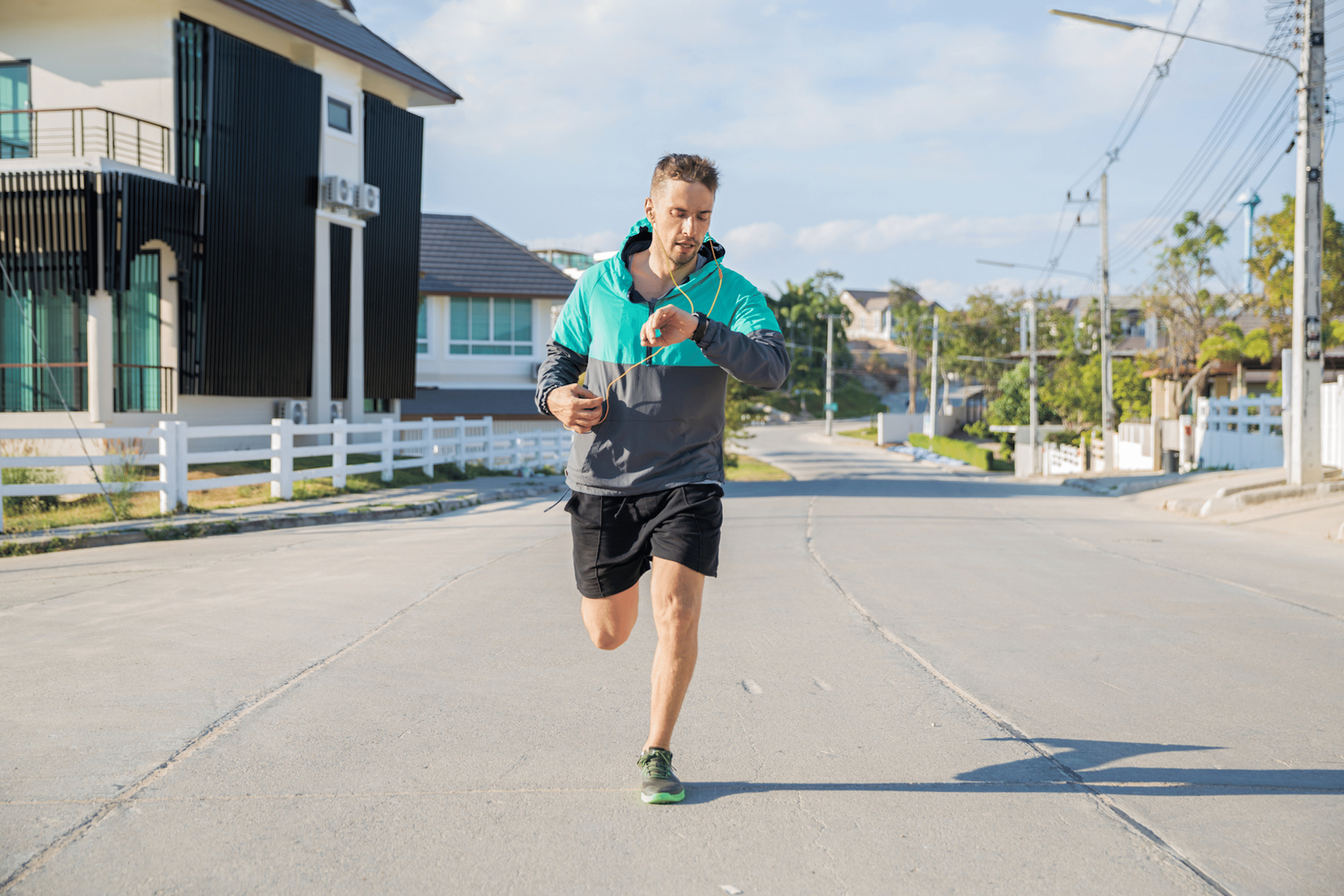 Man checks his watch for negative splits during a run