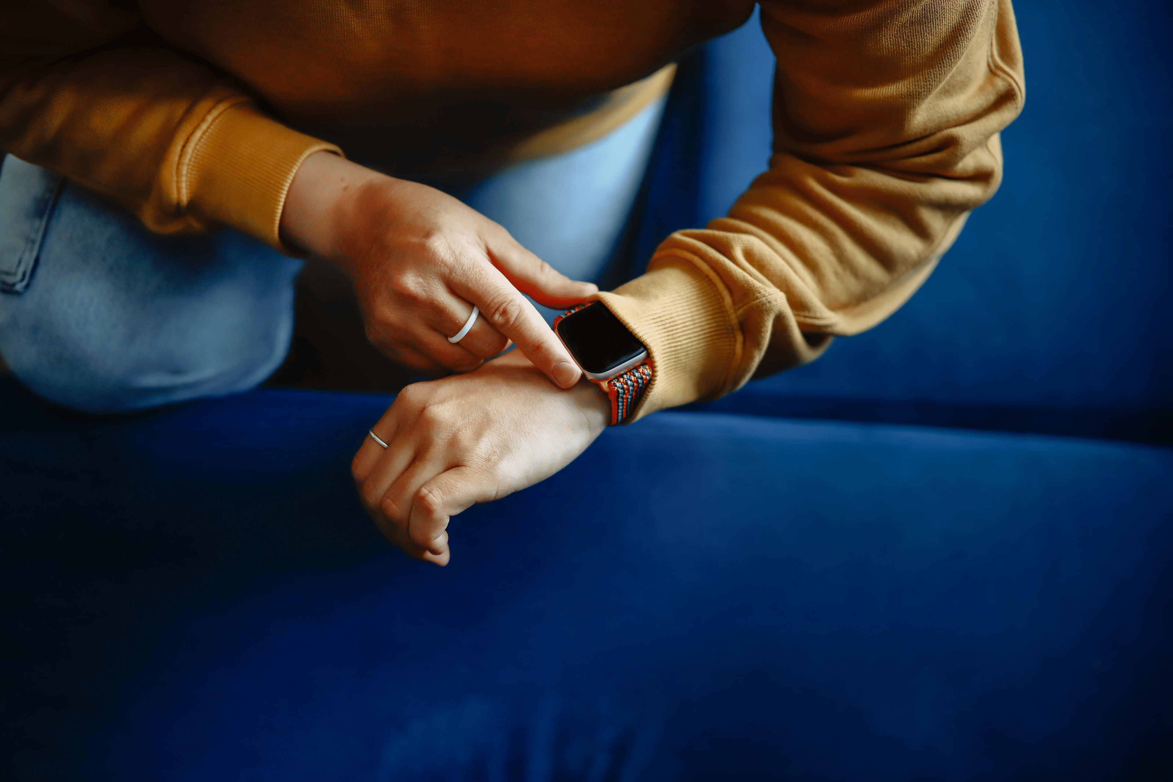 Close up of a woman's hands as she checks her heart rate variability (HRV) on her smartwatch.