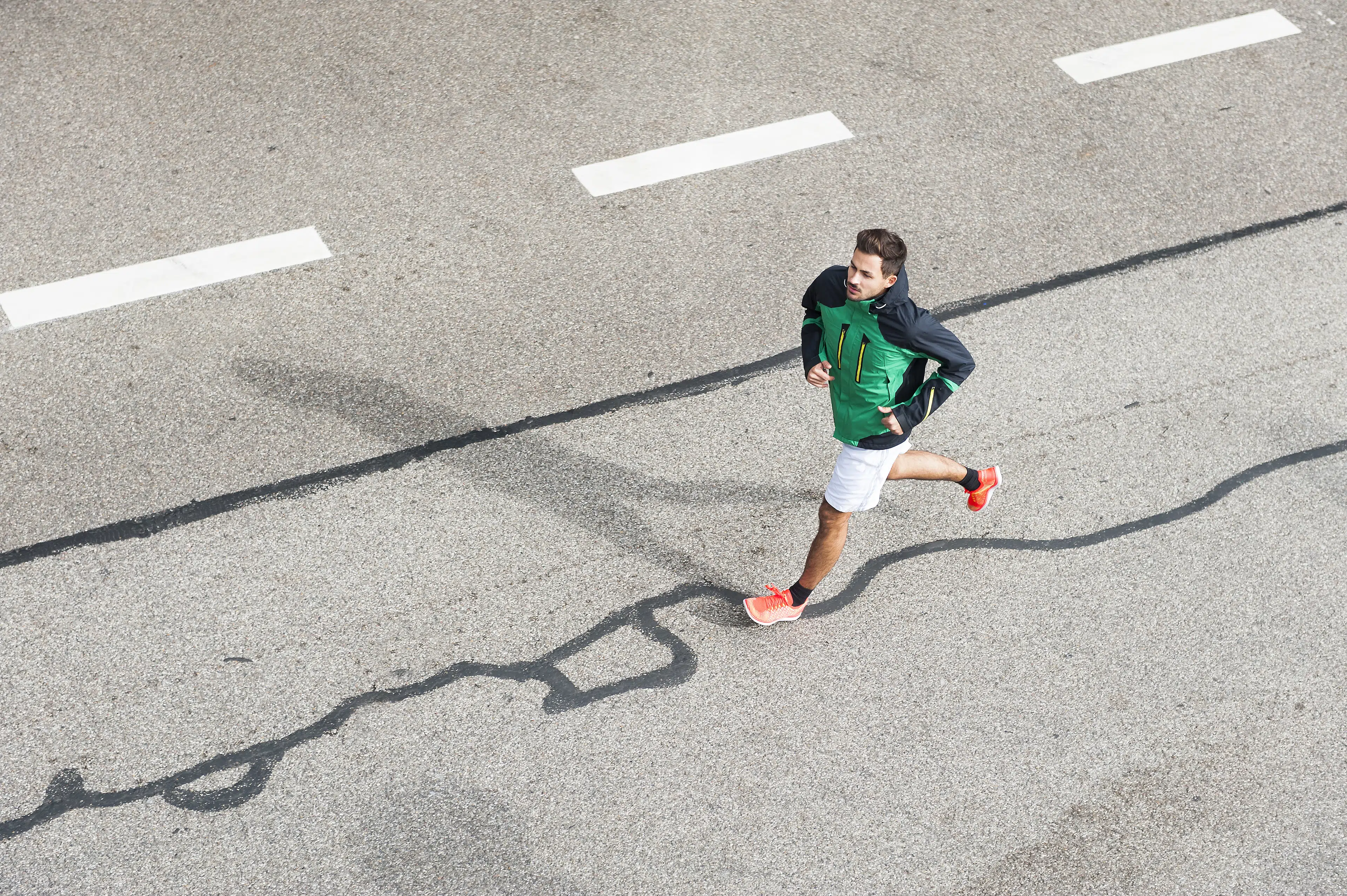 Young man running on a road doing his longest run before a marathon